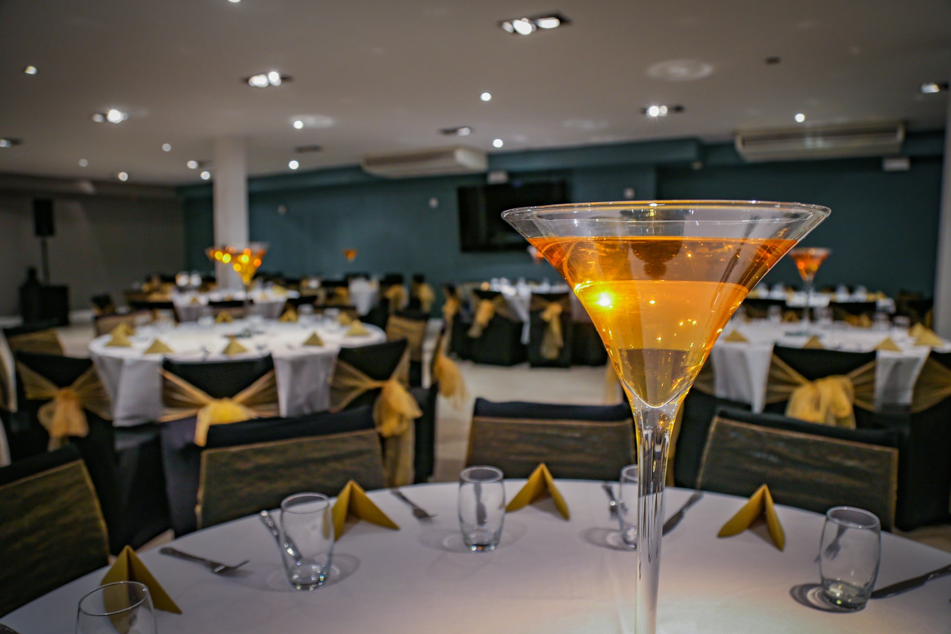 Elegant banquet hall with martini glass centerpiece for weddings and corporate events.