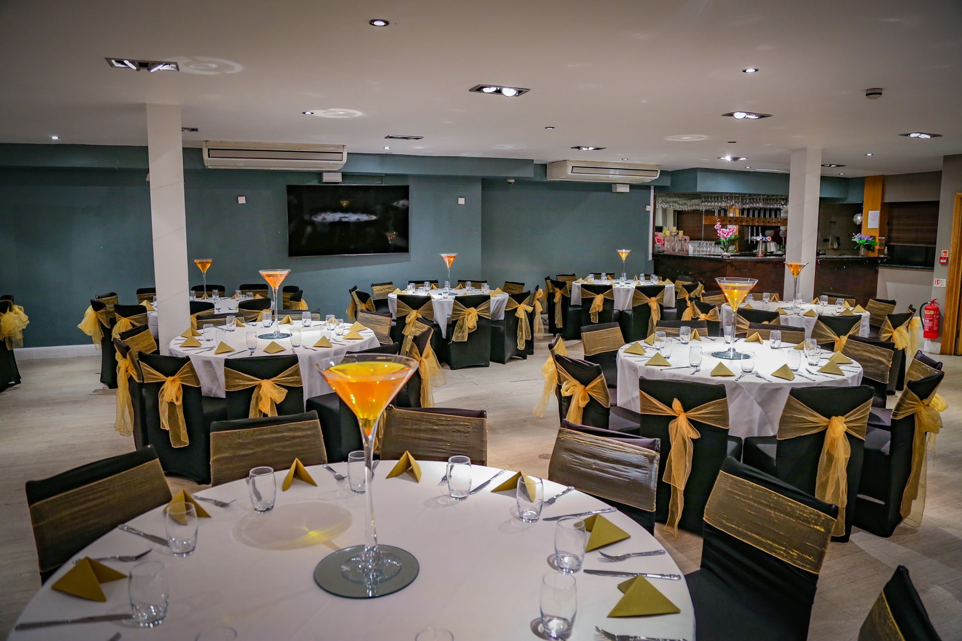 Elegant Mehfil Banquet hall with black and gold decor for formal events and celebrations.