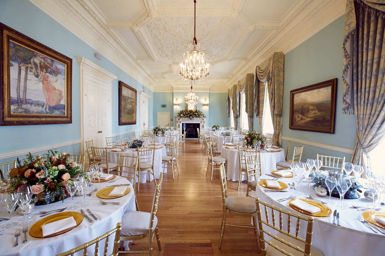 Elegant Long Drawing Room with floral centerpieces, perfect for weddings and corporate events.