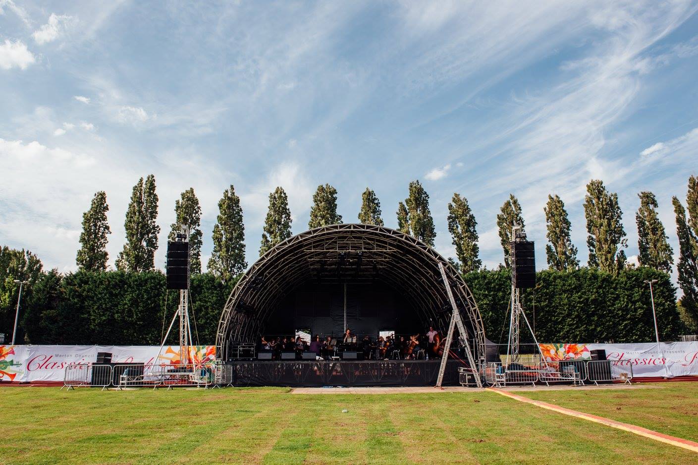 Athletics track in Wimbledon Park, ideal outdoor concert venue with stage and greenery.