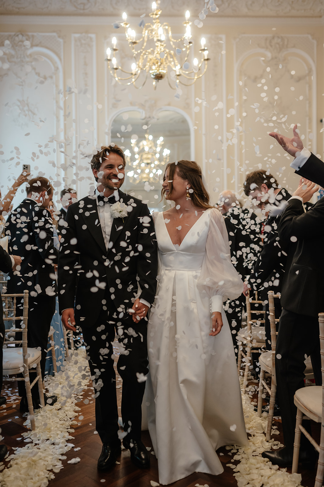 Joyful wedding celebration in Music Room, Carlton House Terrace with confetti and elegant decor.