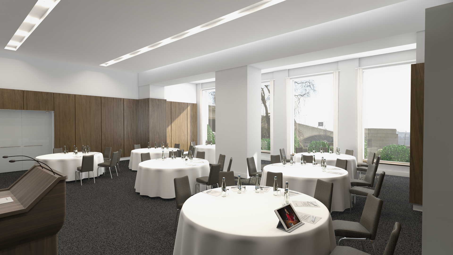 Modern event space with round tables, ideal for corporate events and social gatherings.