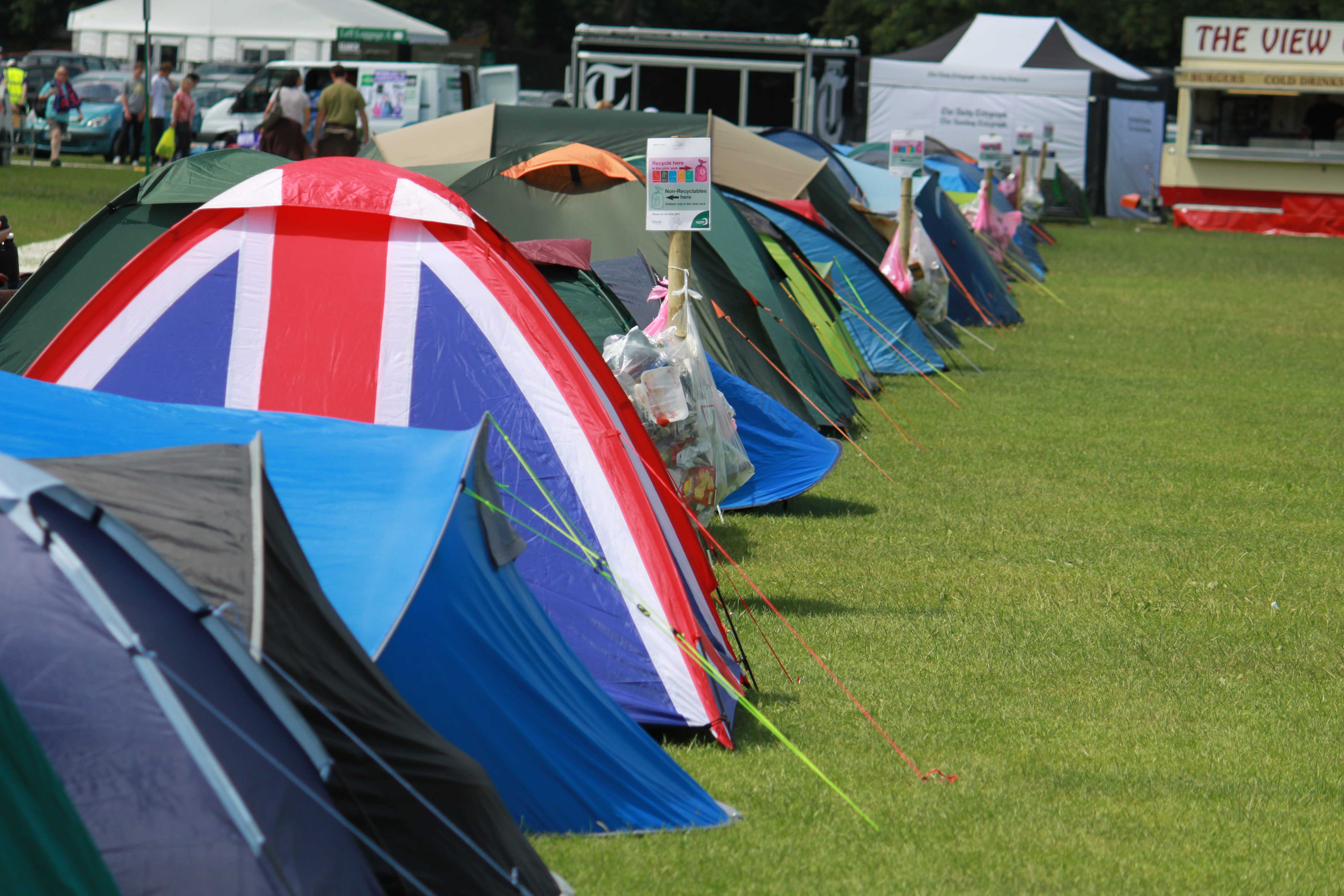Vibrant campsite in Wimbledon Park with colorful tents for outdoor events and festivals.
