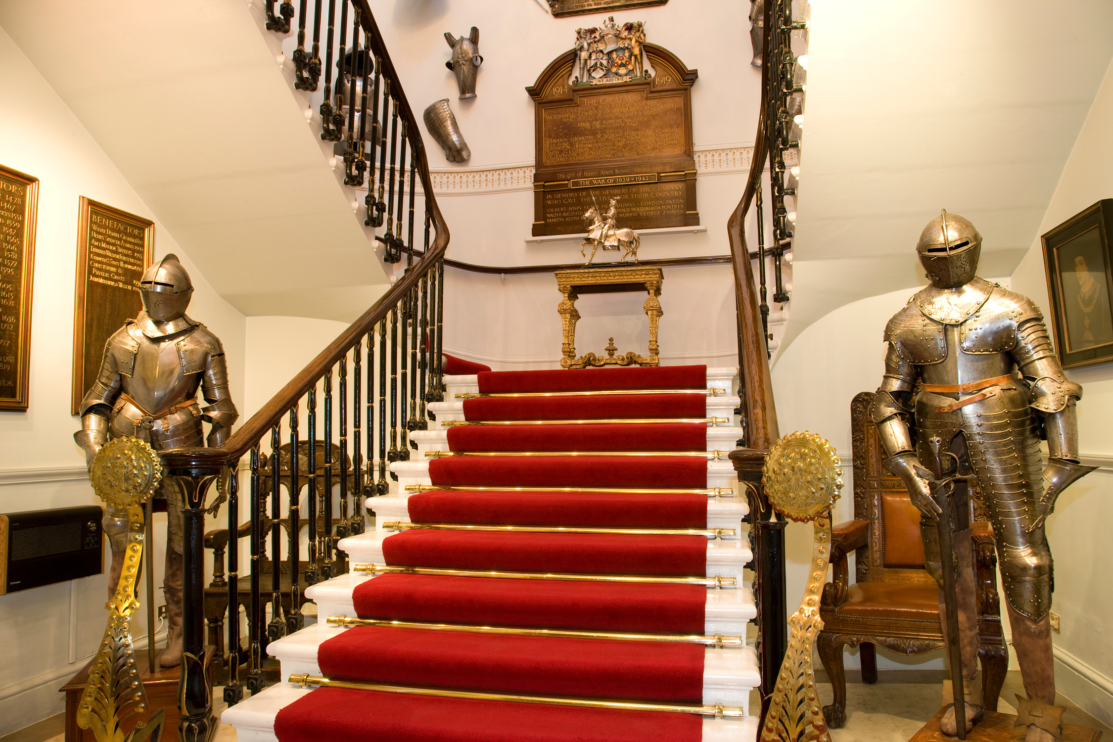 Grand staircase with suits of armor at Armourers' Hall, perfect for upscale events.