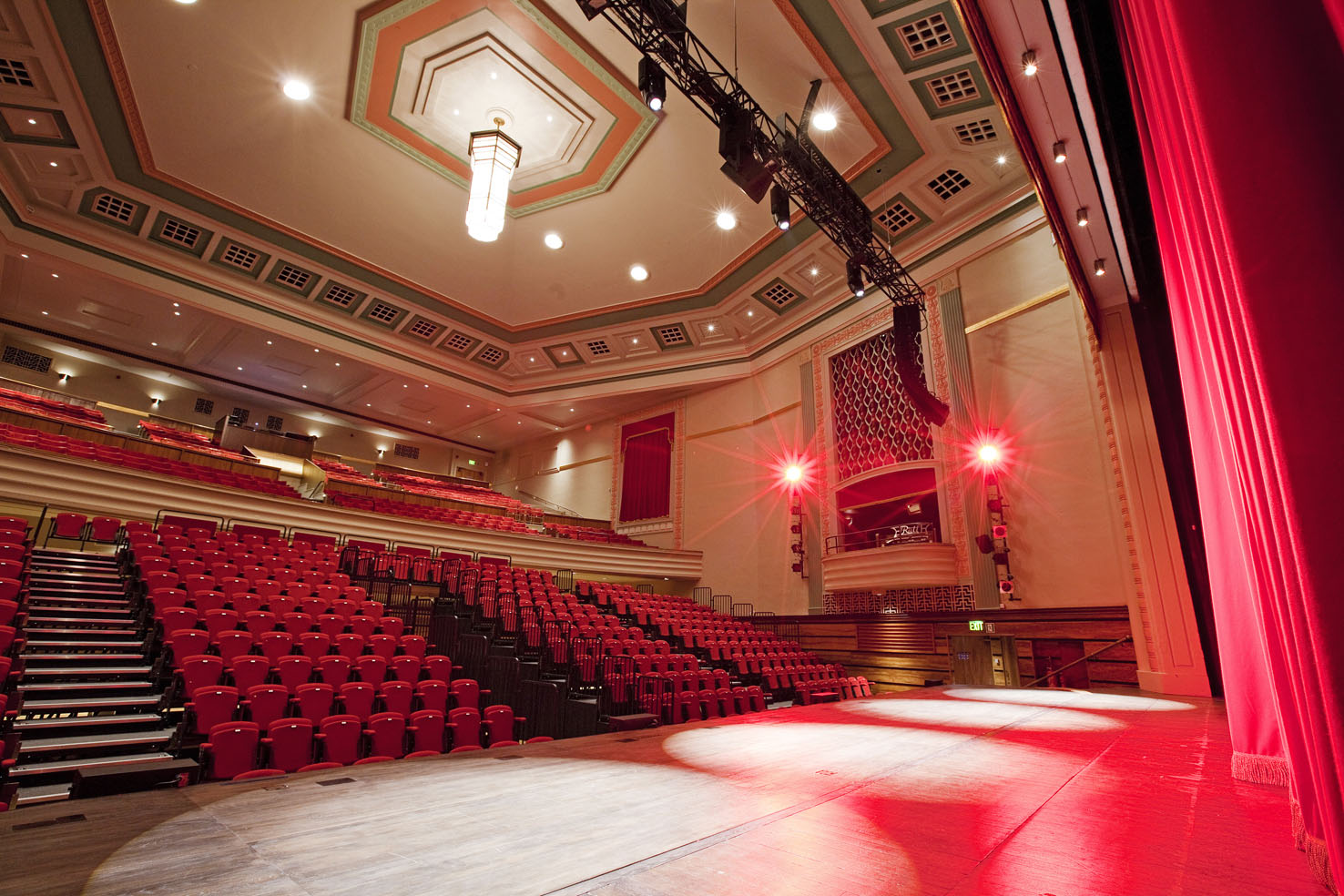 Great Hall Theatre auditorium with red curtains, ideal for conferences and performances.