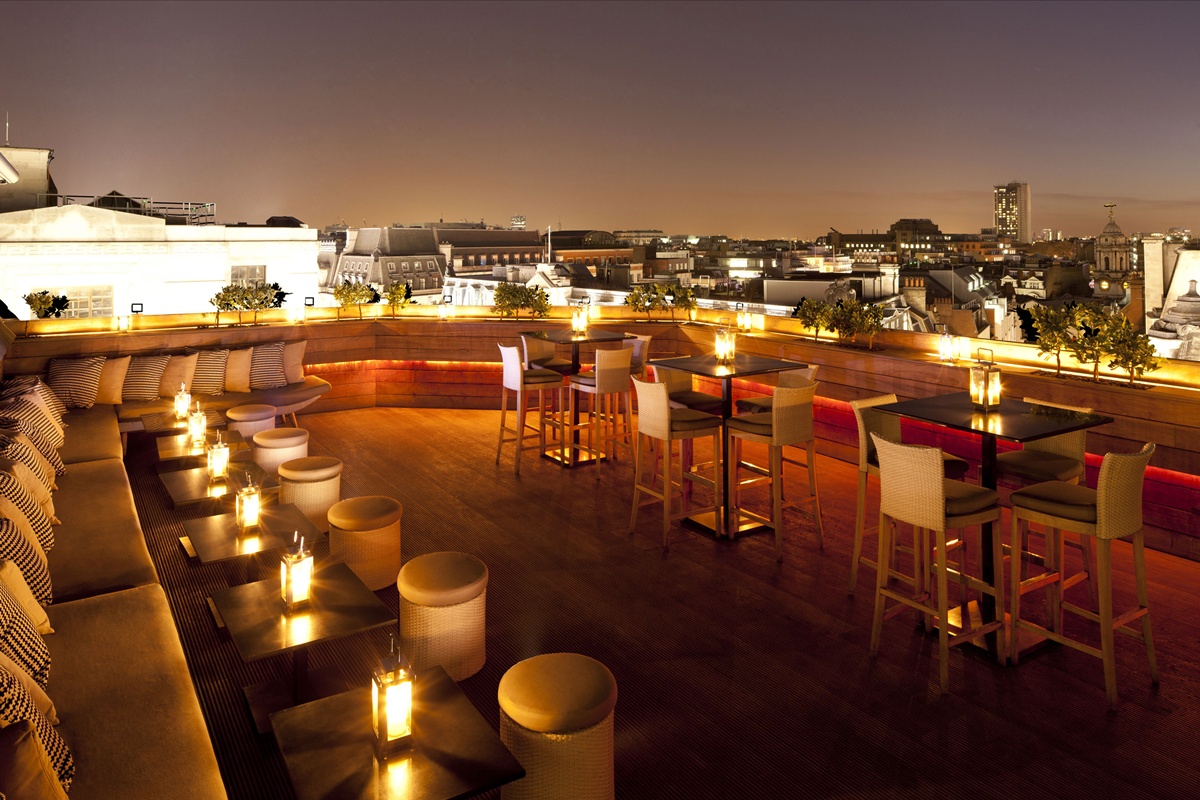 Stylish rooftop bar with ambient lighting, perfect for cocktail receptions and gatherings.