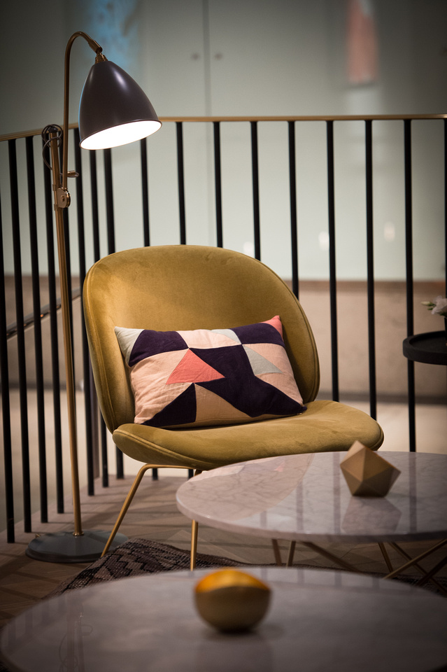 Stylish chair with geometric pillow in The Long Room, perfect for event networking.