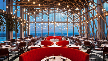 Modern event space at SUSHI SAMBA with elegant red seating and stunning views.