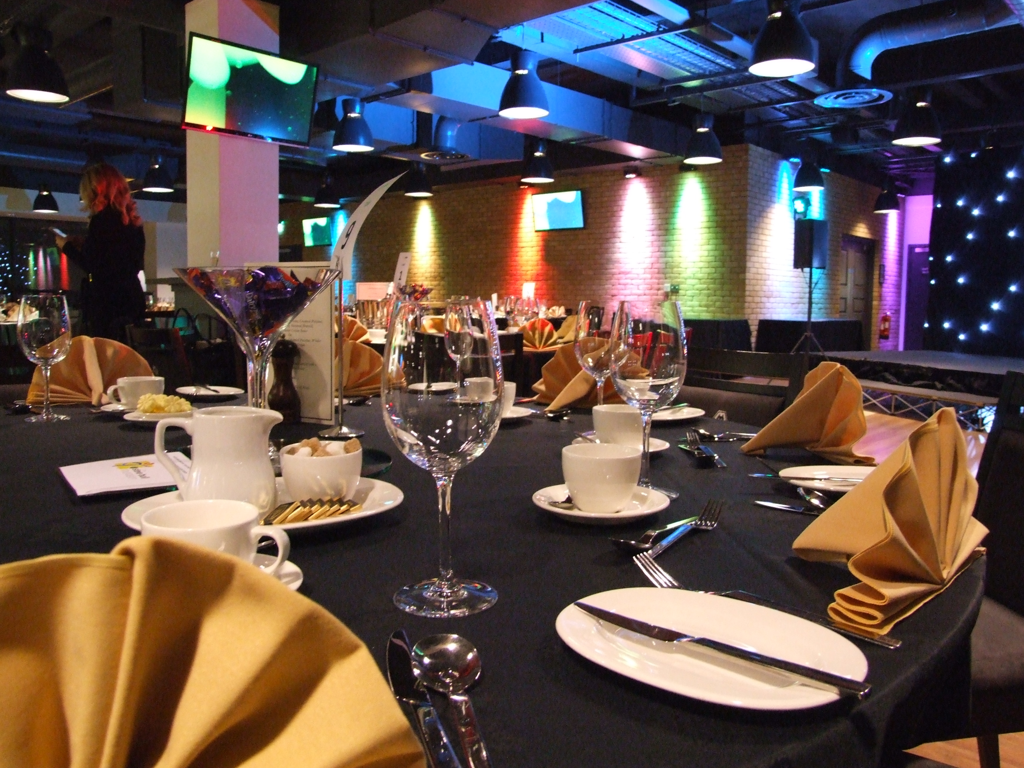 Elegant event space at Molineux Stadium with gold napkins, ideal for dinners and networking.