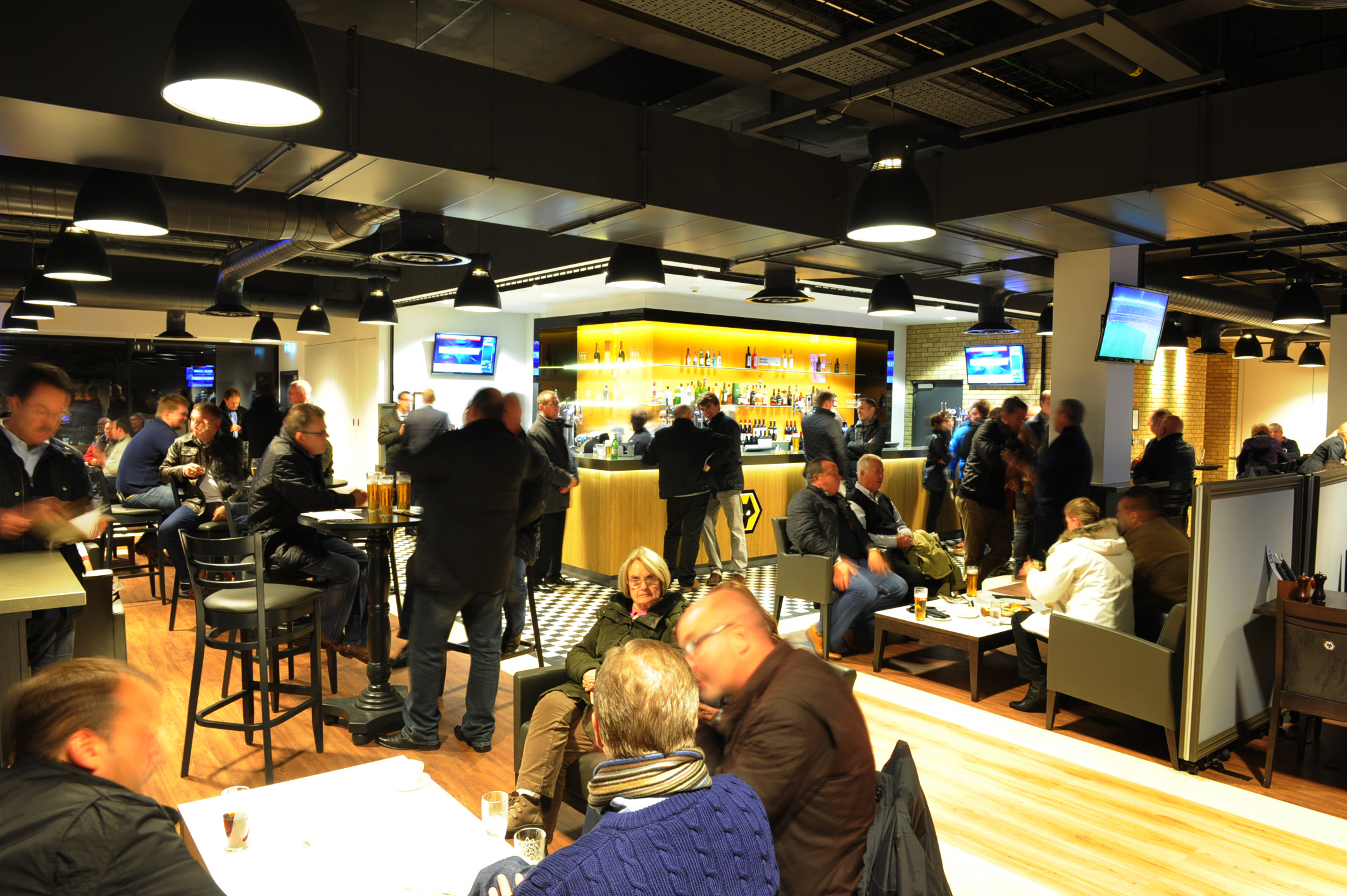 Lively networking event at WV1 Bar, Molineux Stadium, with modern seating and ambiance.