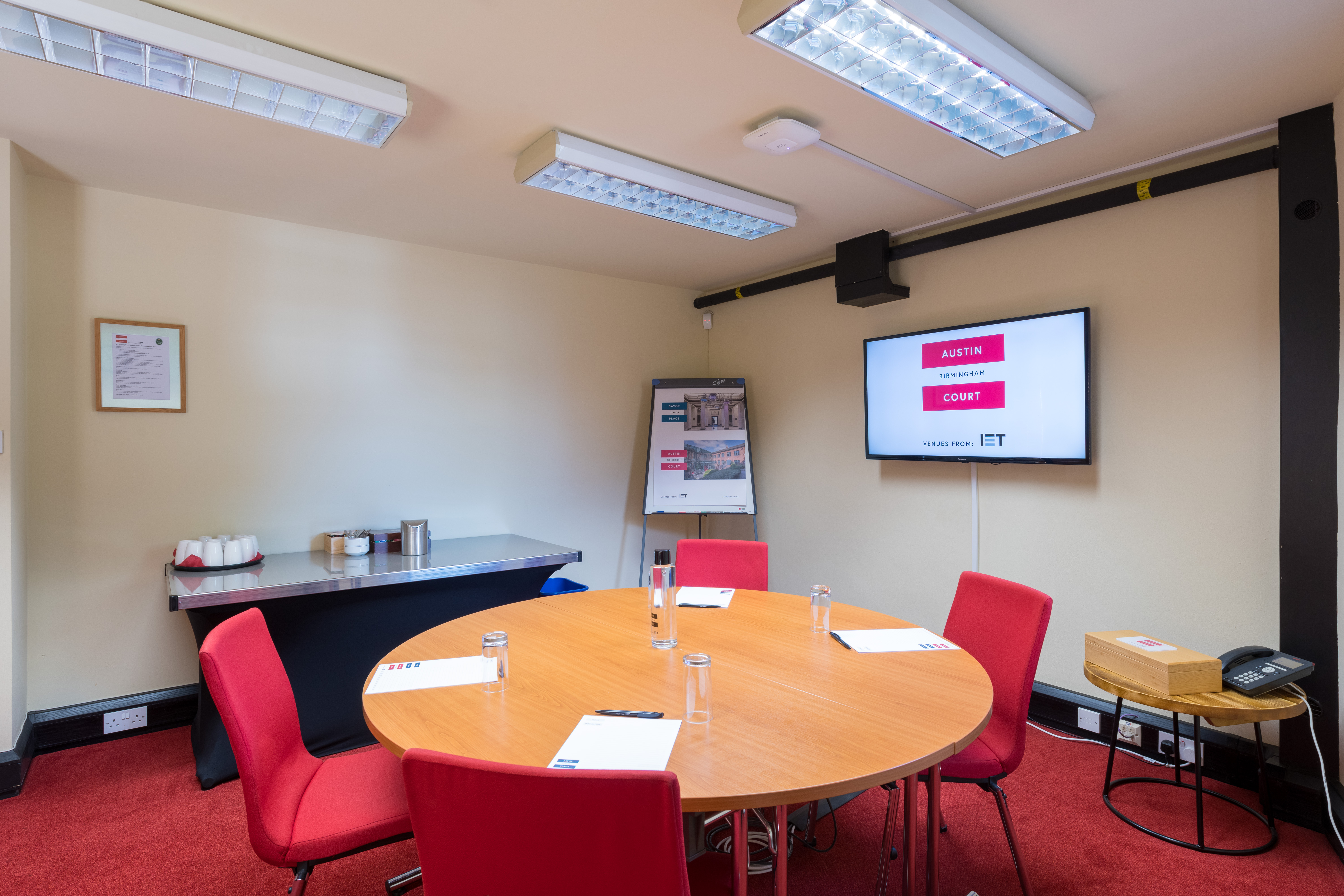 Brindley Room at IET Birmingham: modern meeting space with round table and red chairs.