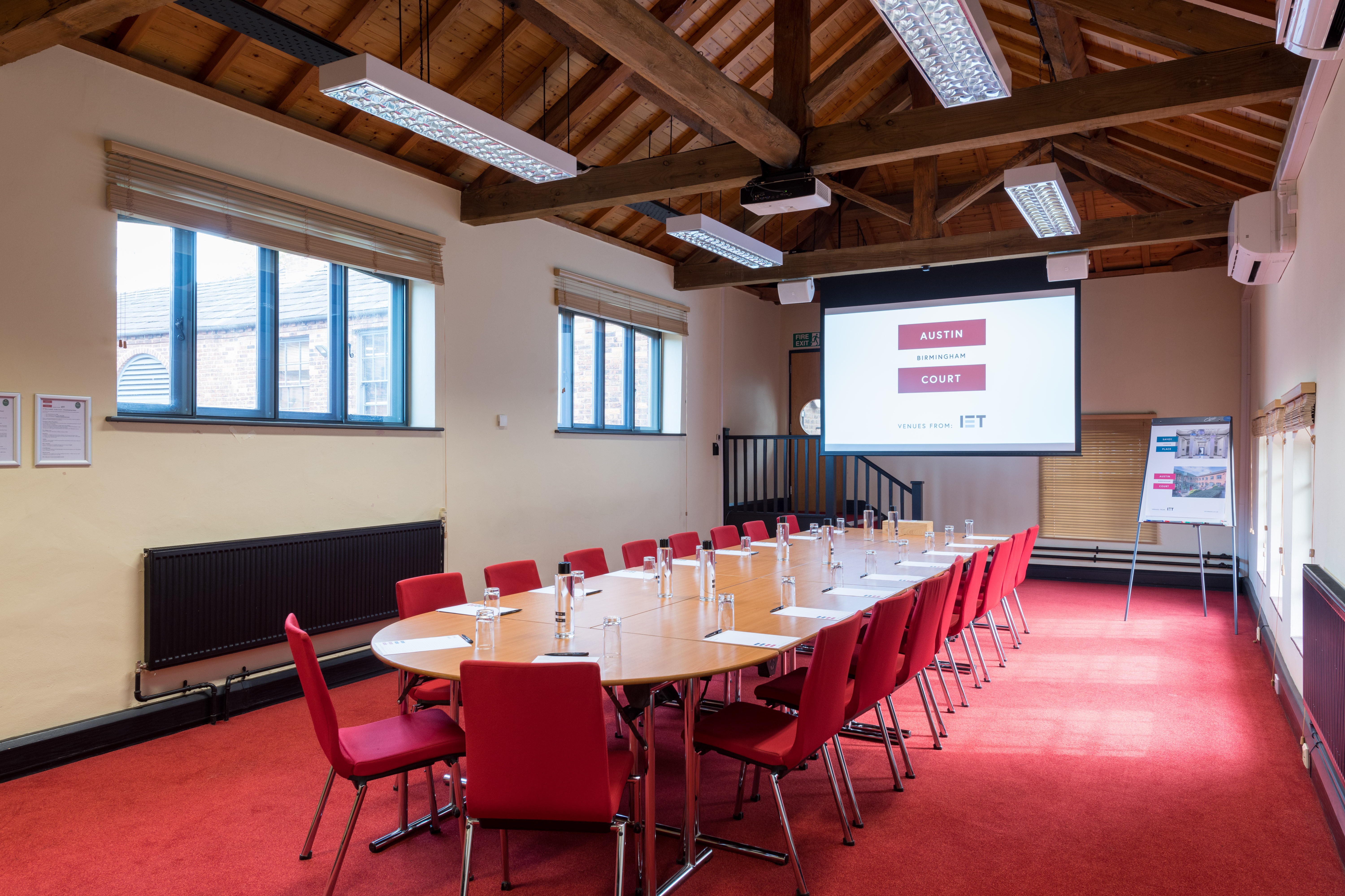 Crompton Room at IET Birmingham: round table, red chairs, ideal for workshops and meetings.
