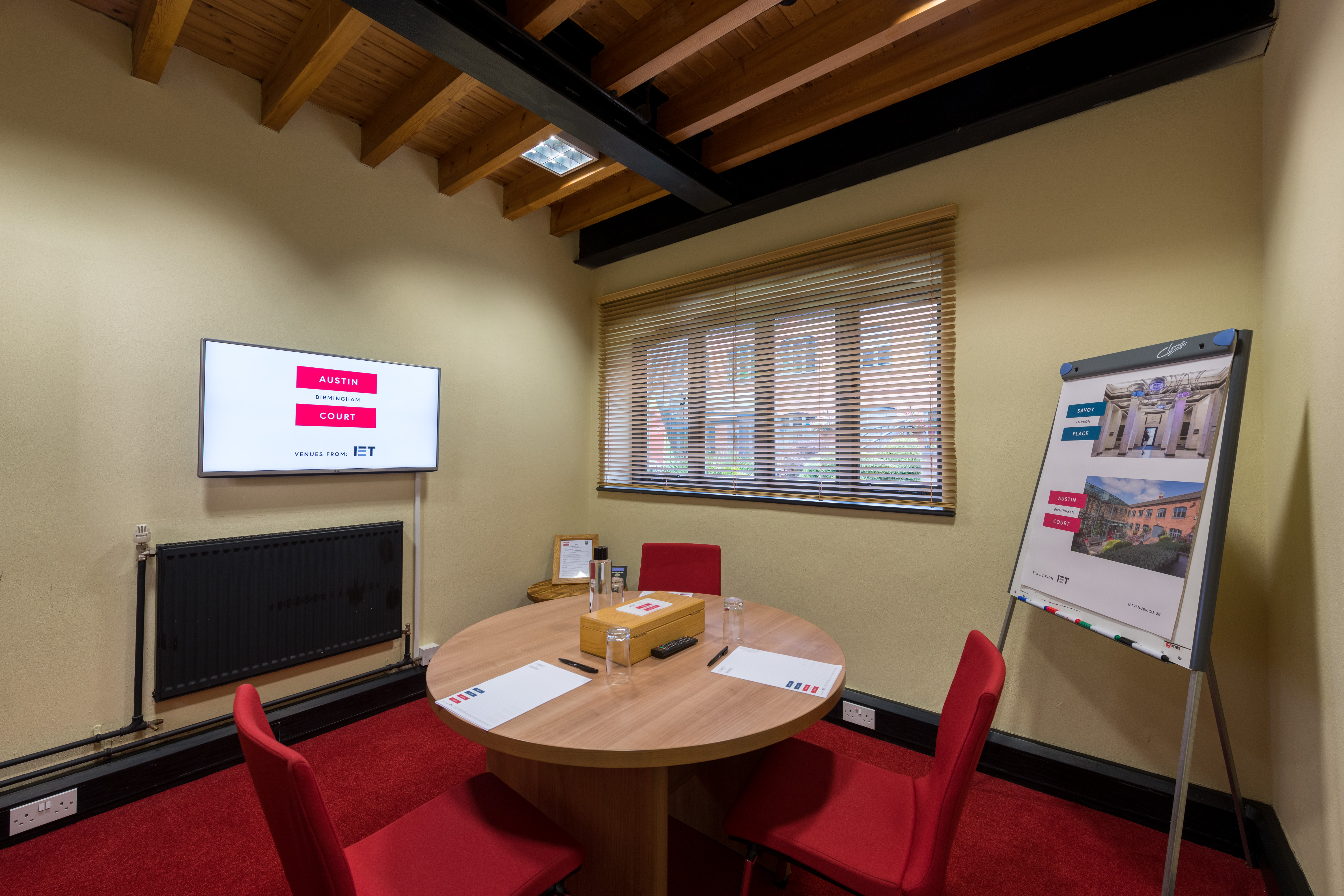 Edison Room at IET Birmingham: modern meeting space with round table for collaboration.