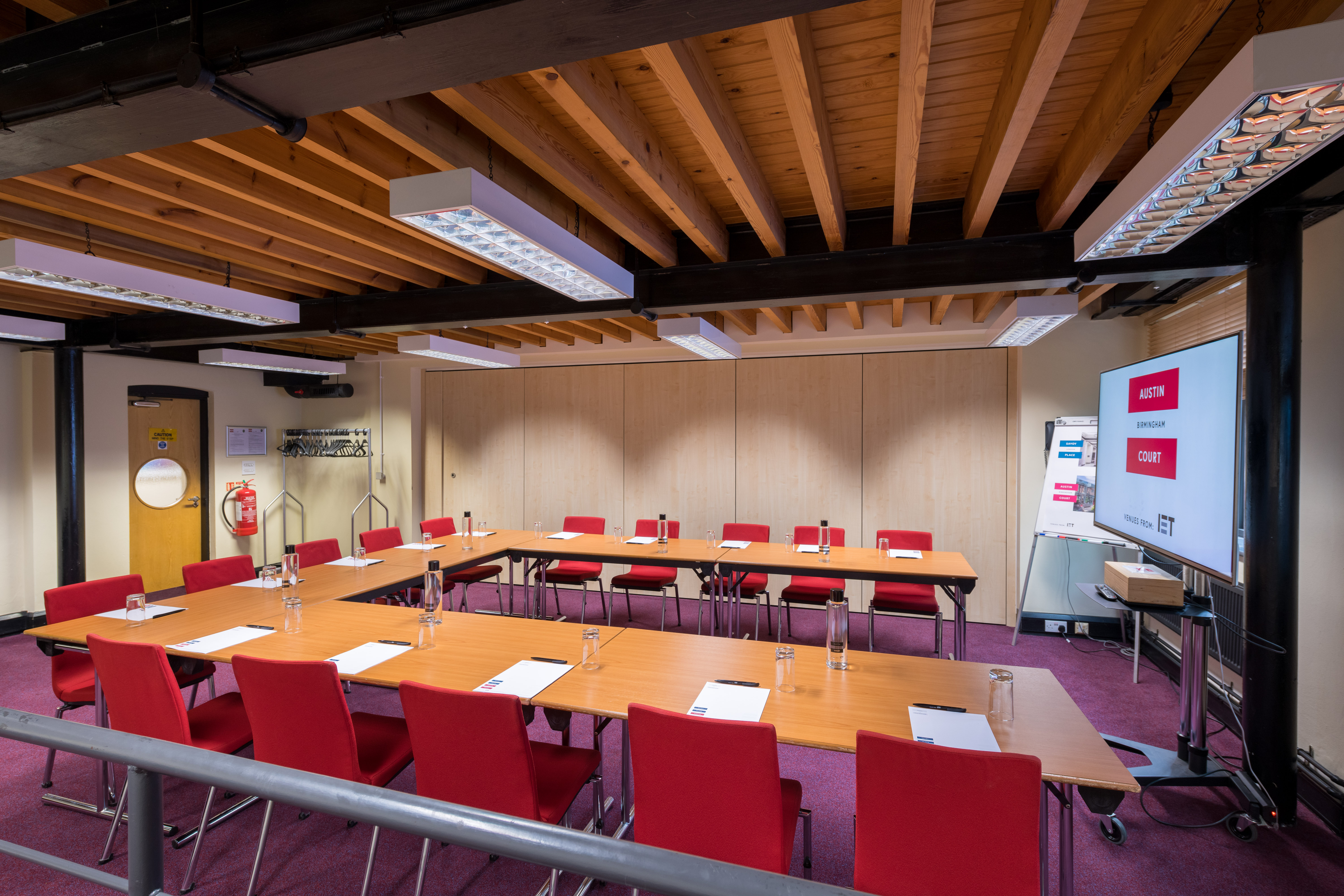 Faraday Room at IET Birmingham: U-shaped table, red chairs for meetings and workshops.