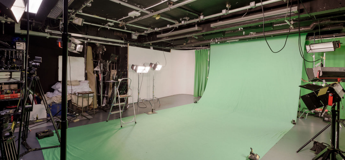 Versatile green screen TV studio with professional lighting for virtual events and live streaming.