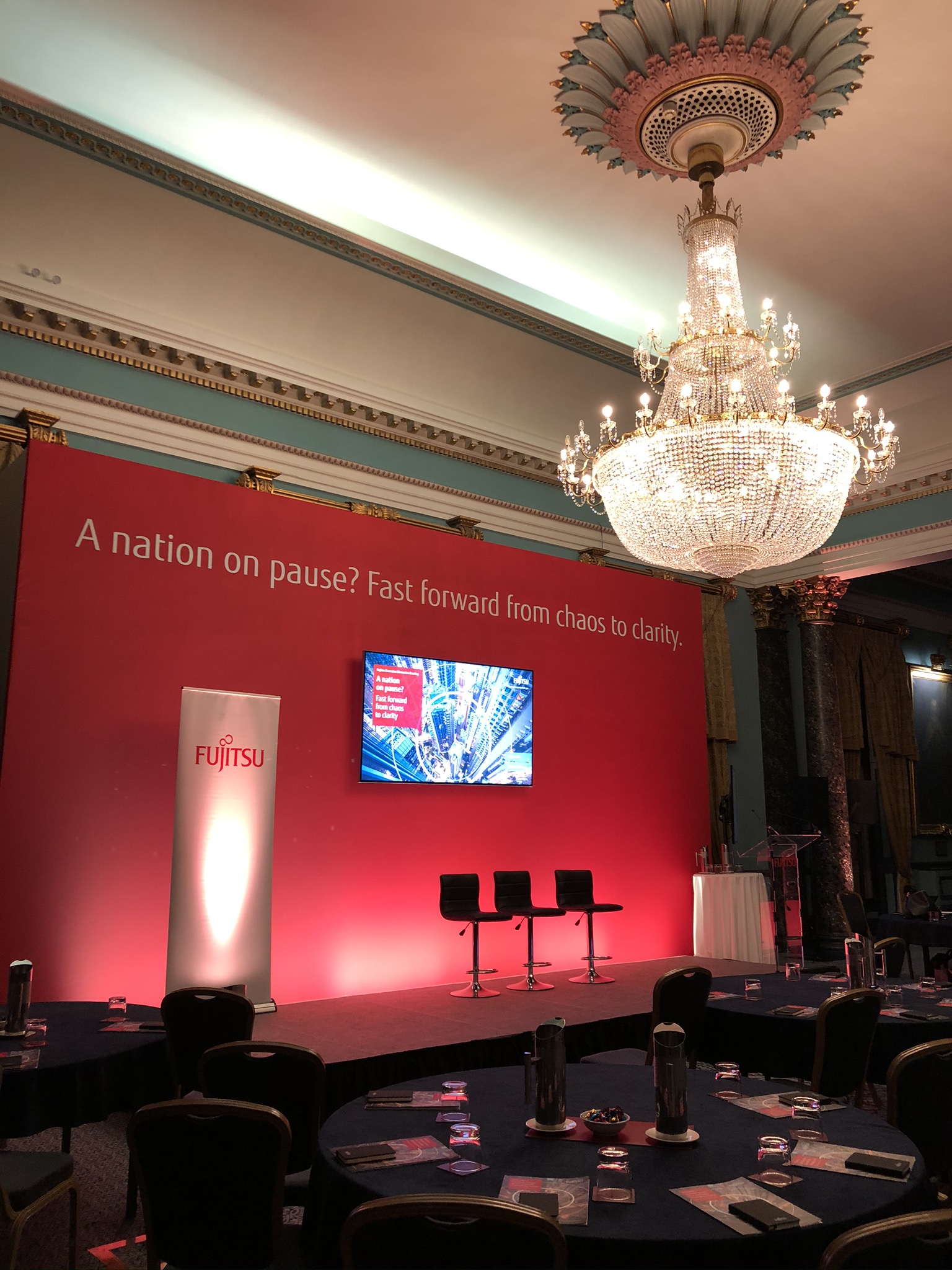 Nash Room at 116 Pall Mall: elegant event space with red backdrop for corporate conferences.