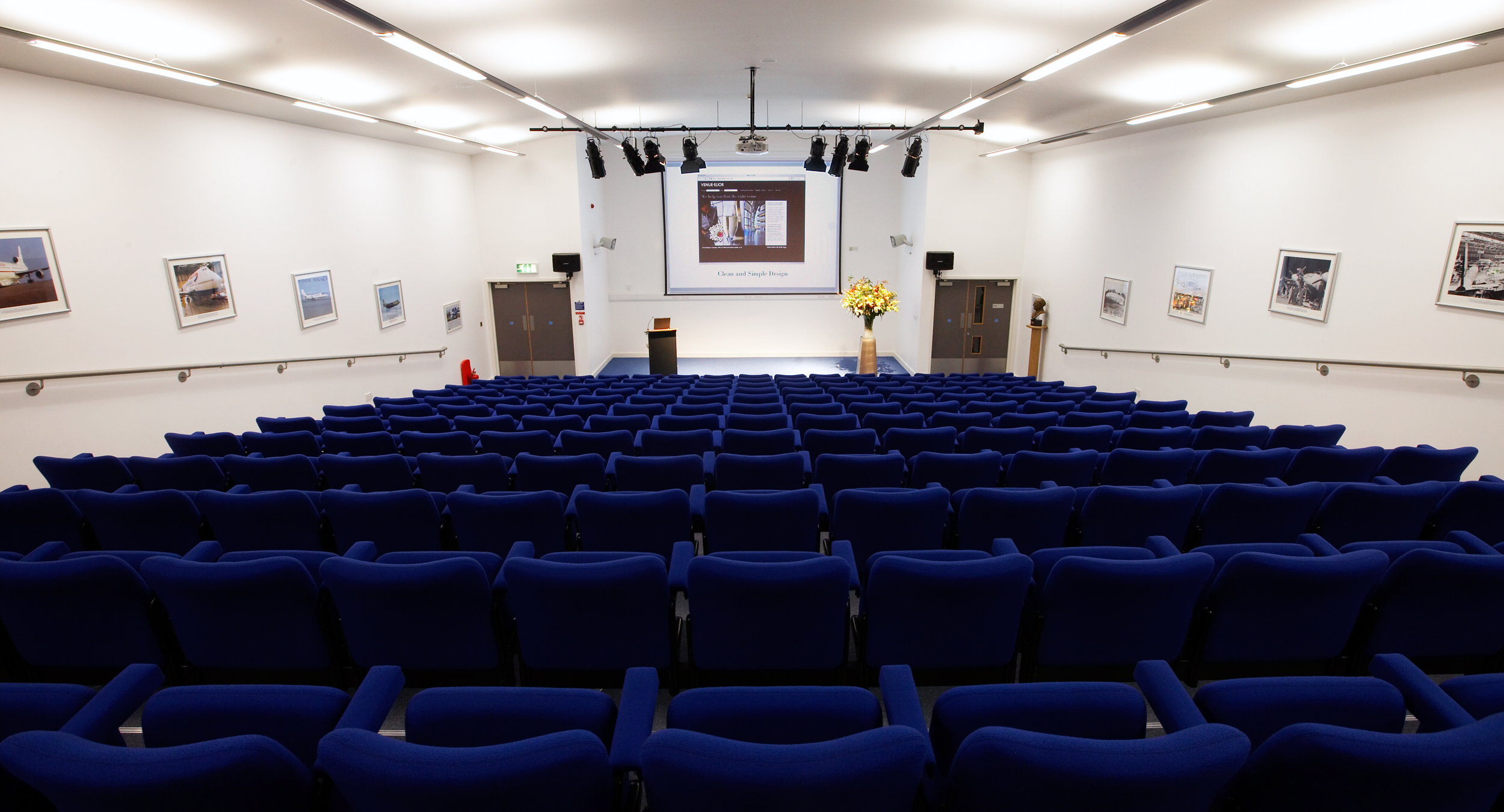 Marshall Auditorium at IWM Duxford with tiered blue seating for corporate events and seminars.