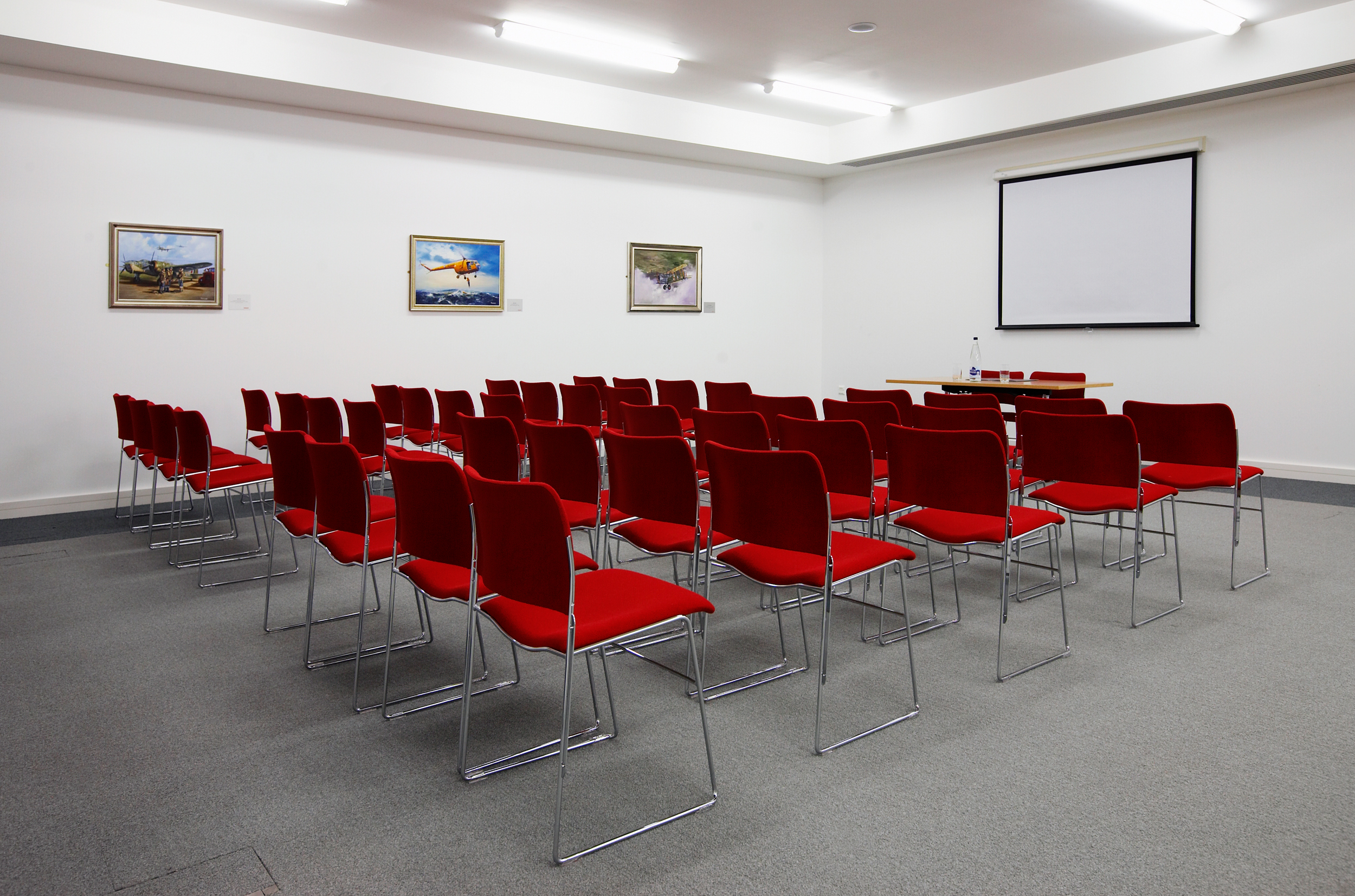 Concorde Suite at IWM Duxford, red chairs arranged for workshops and seminars.