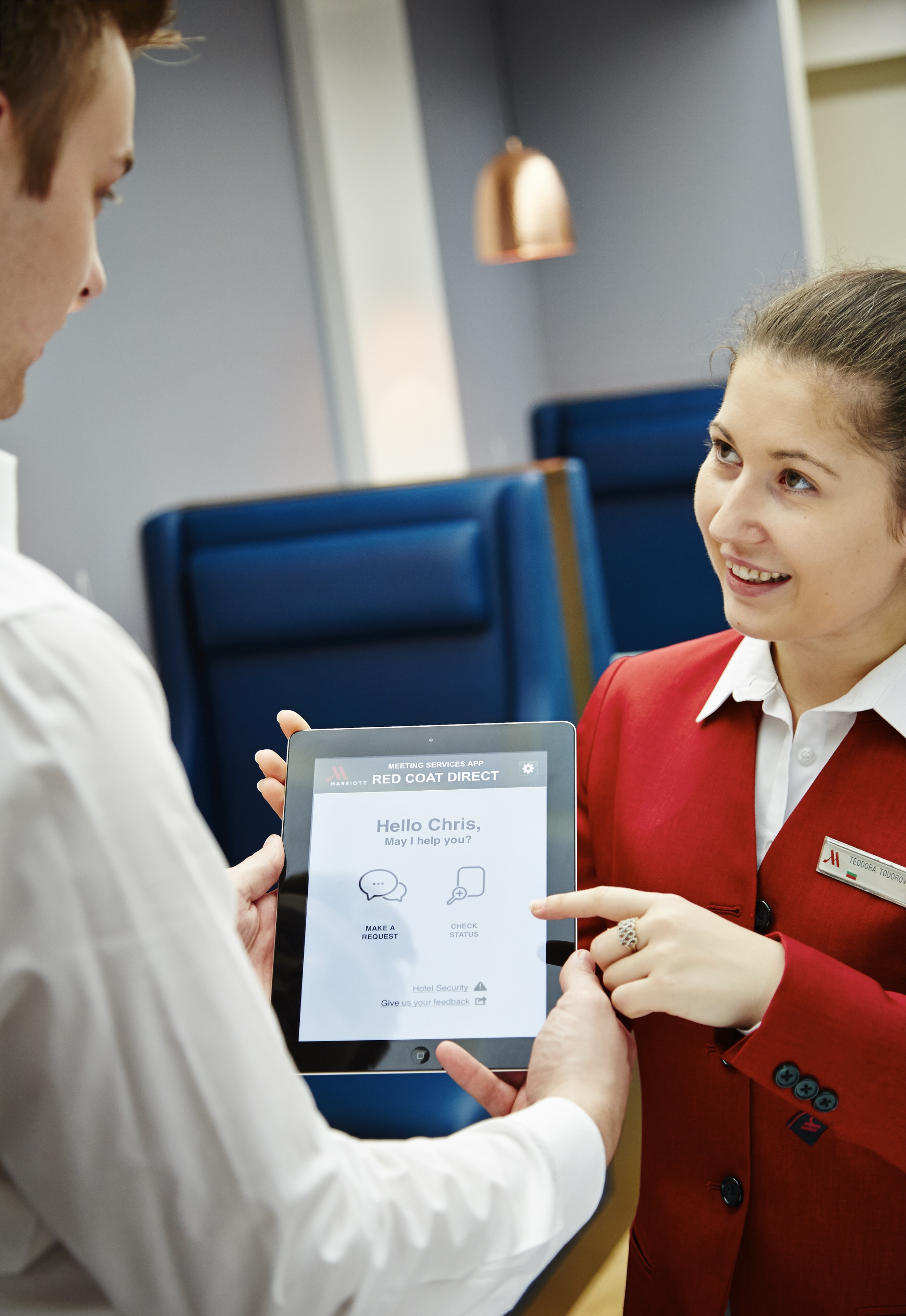 Event staff using tablet in Studio 1, London Marriott Hotel Kensington for efficient management.