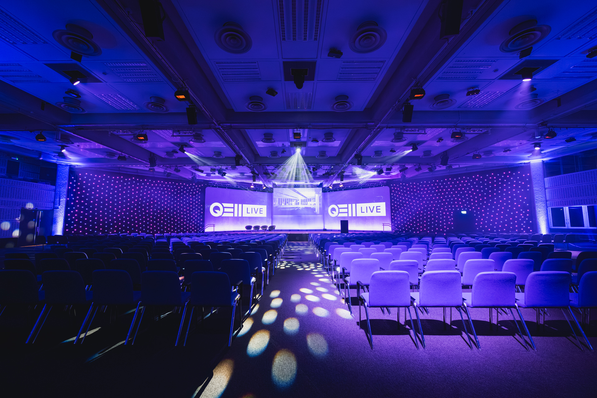 Event space at QEII Centre with auditorium setup, ideal for presentations and performances.