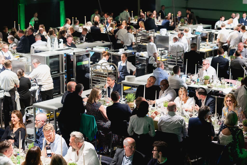 Experiential dining event at QEII Centre with open kitchen catering for corporate events.