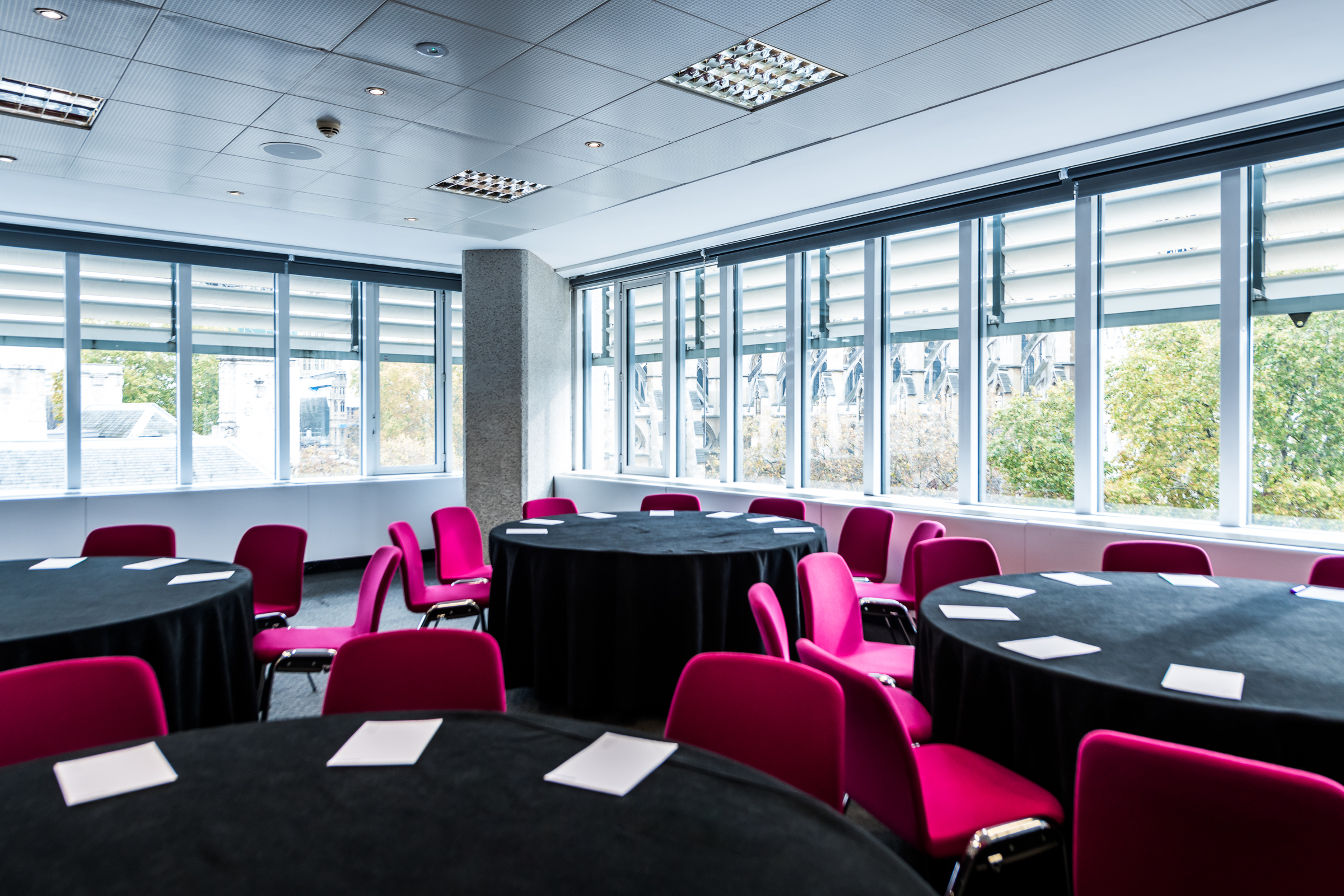 Abbey in QEII Centre: bright meeting space with round tables for workshops and conferences.