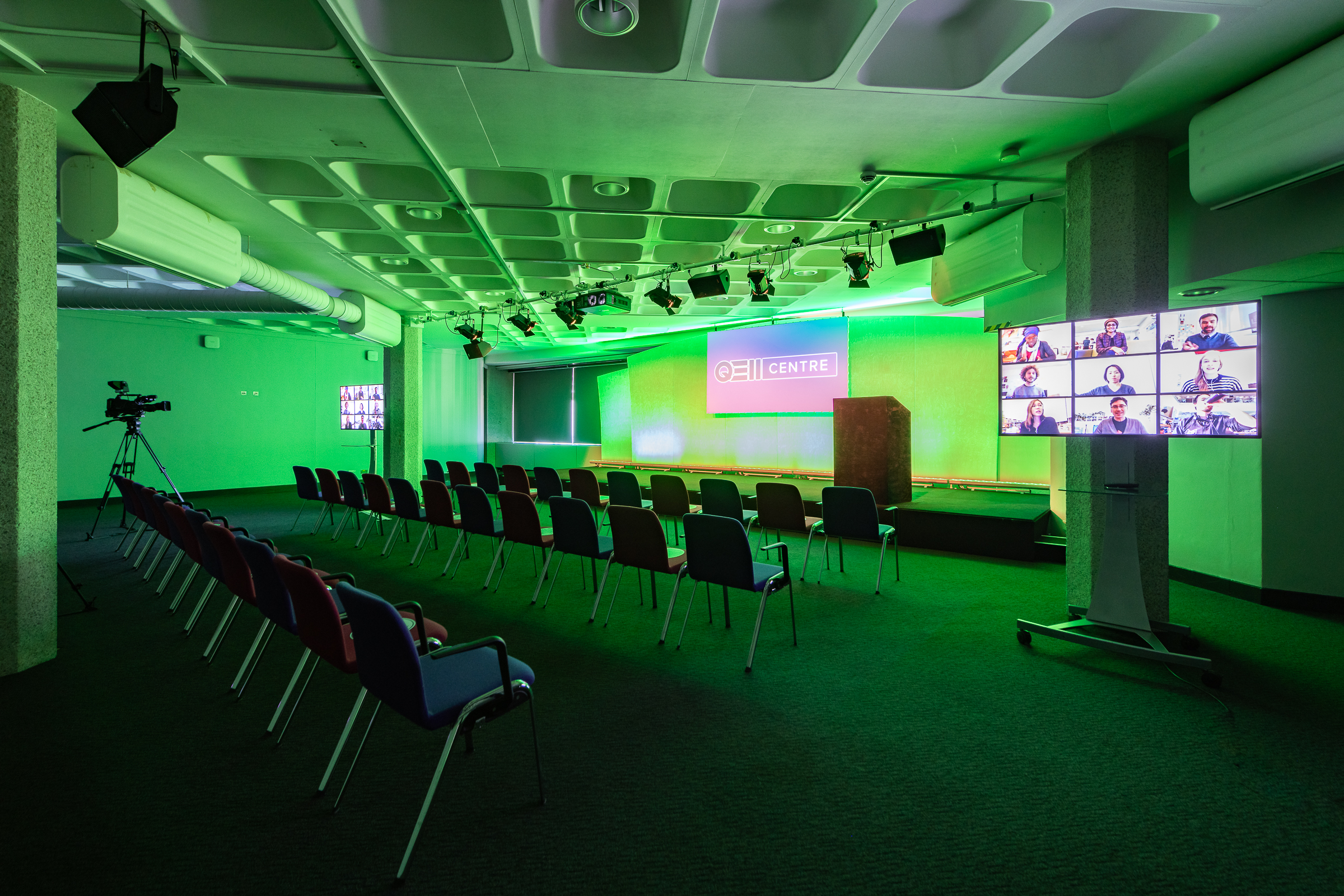 St James hybrid event space with green lighting for engaging presentations and discussions.