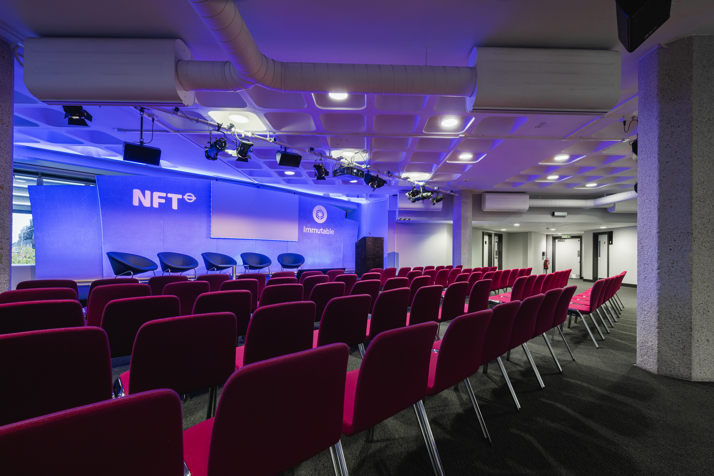 Modern event space at St James, QEII Centre, ready for presentations and discussions.