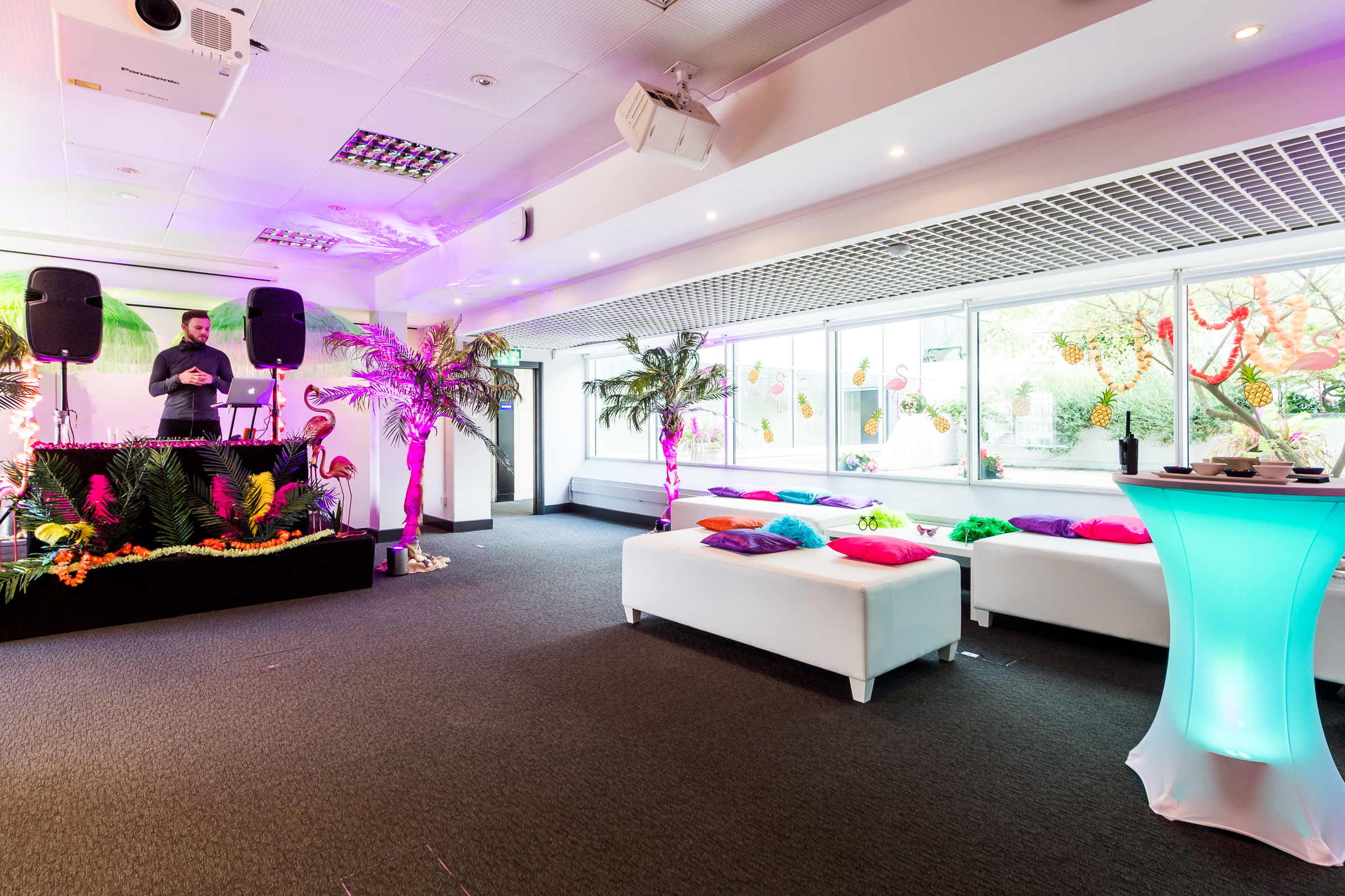 Vibrant event space in QEII Centre with DJ setup for networking and celebrations.