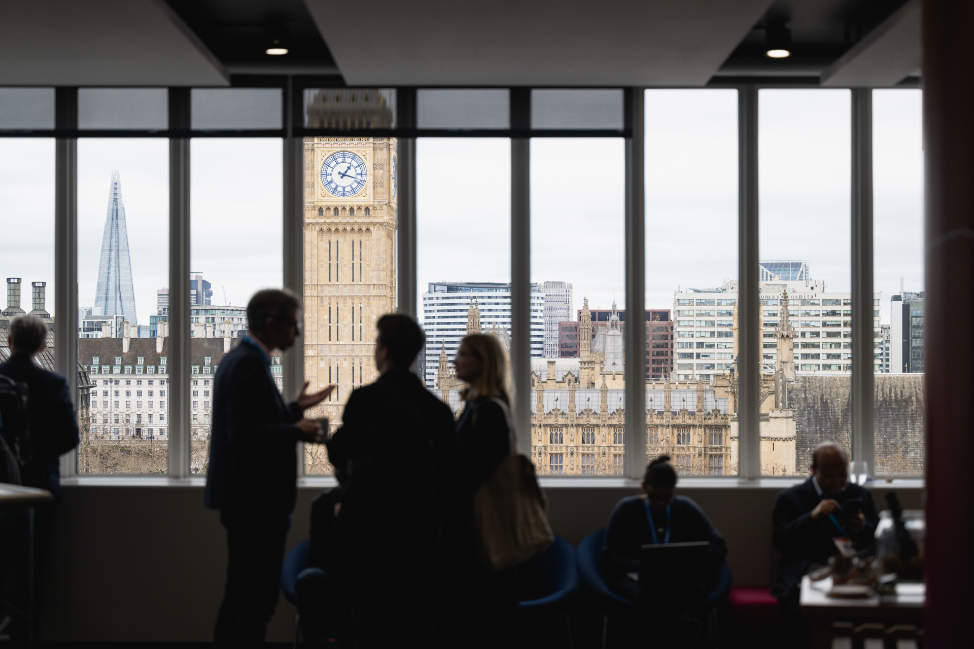 Cambridge networking event in QEII Centre with iconic London skyline backdrop.