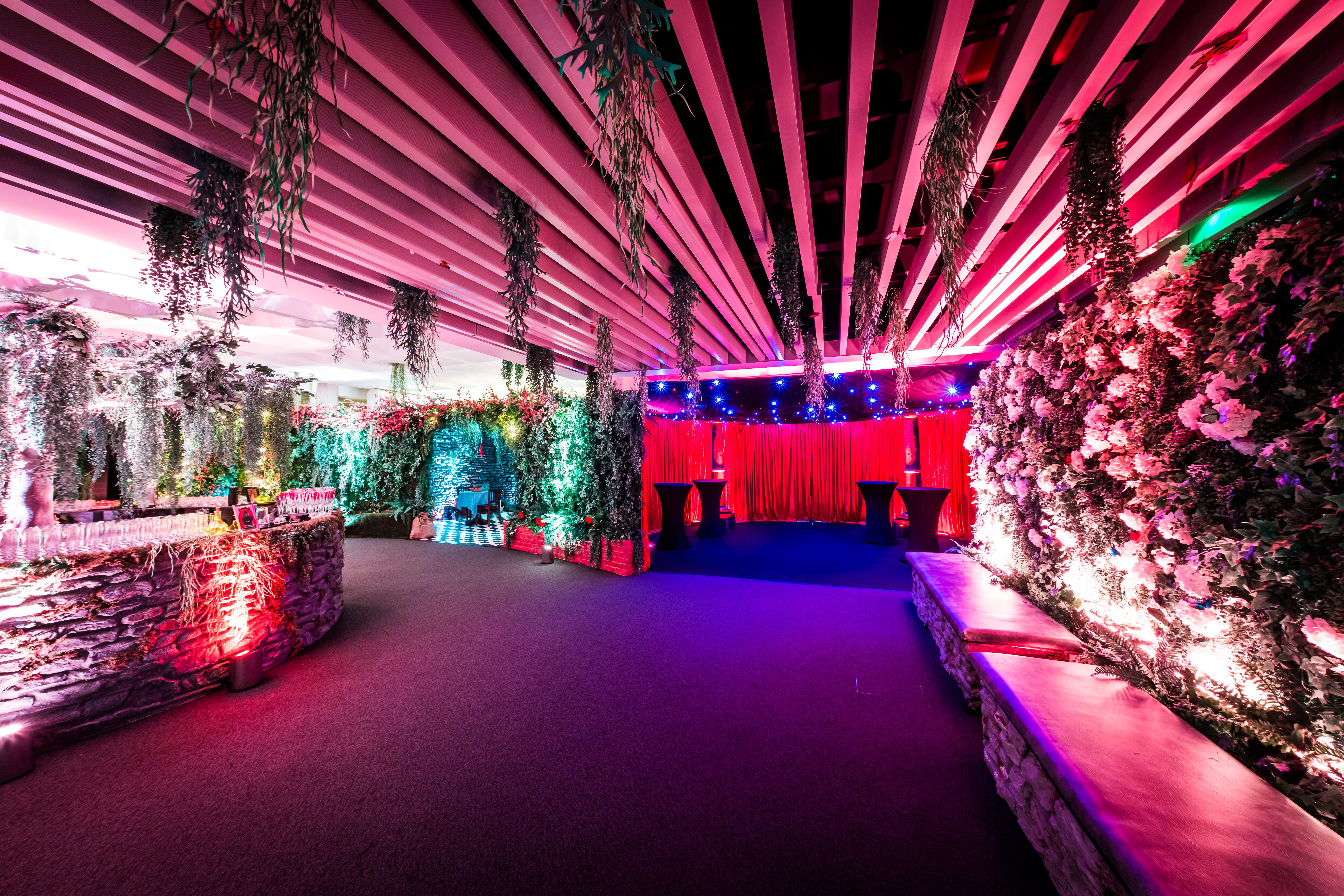 Vibrant event space in QEII Centre, featuring lush florals for social gatherings.