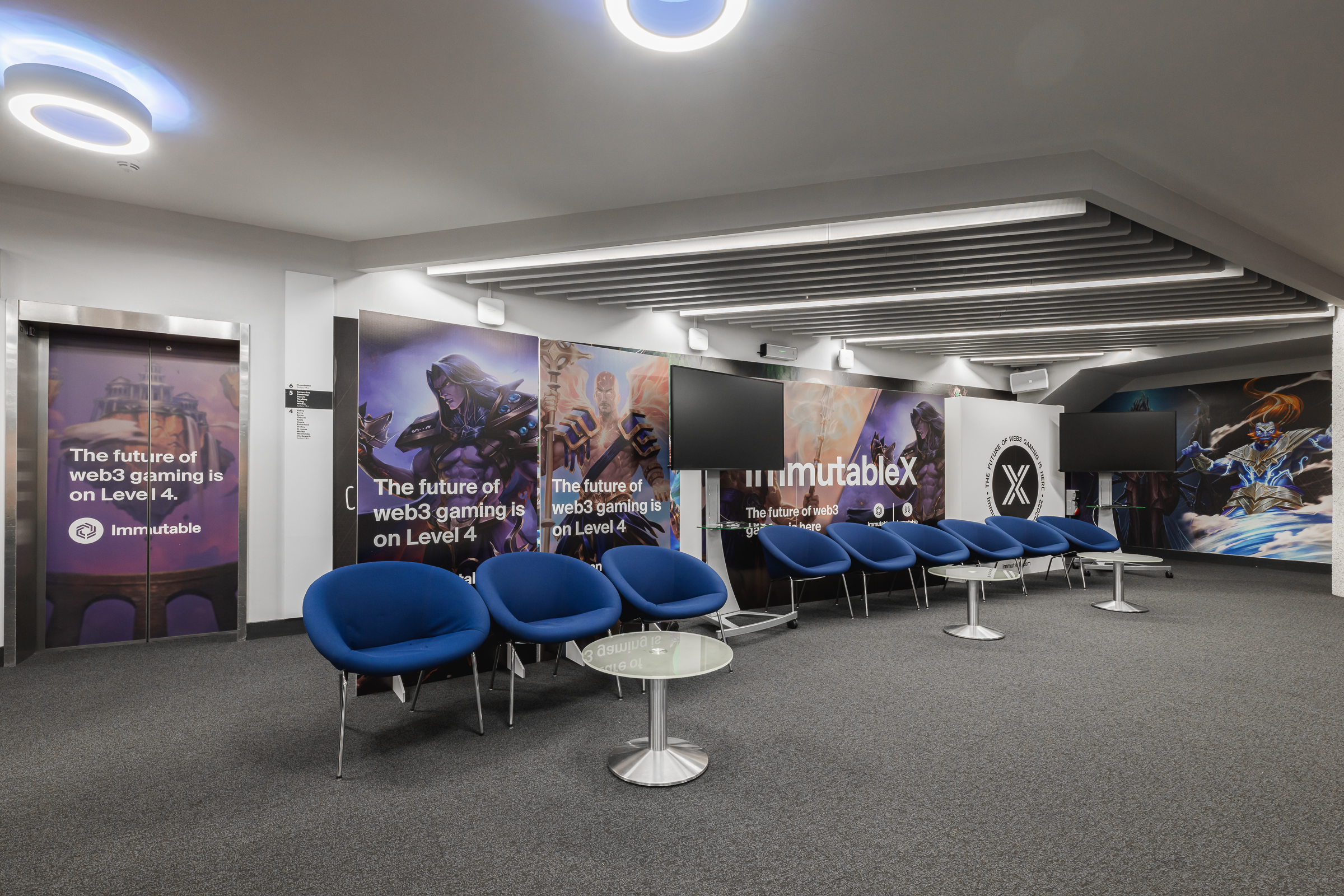 Modern Cambridge event space with blue seating for web gaming presentations and networking.