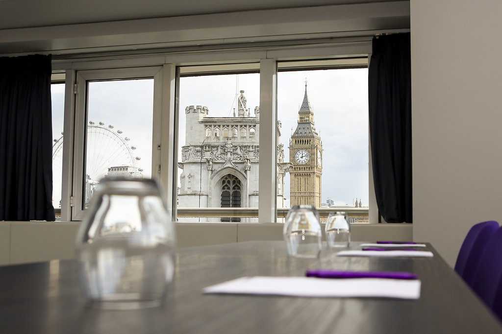 Modern meeting room in QEII Centre with views of Big Ben and London Eye, perfect for events.