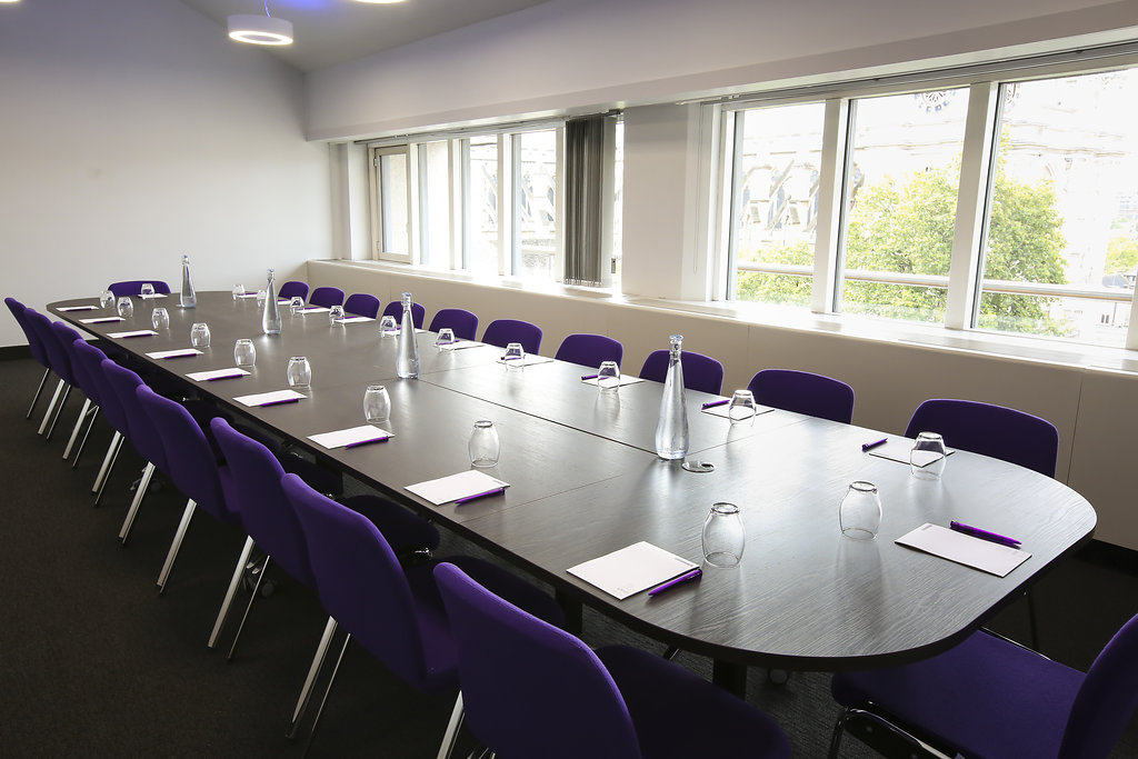 Darwin meeting room with modern purple chairs, ideal for workshops and collaboration.
