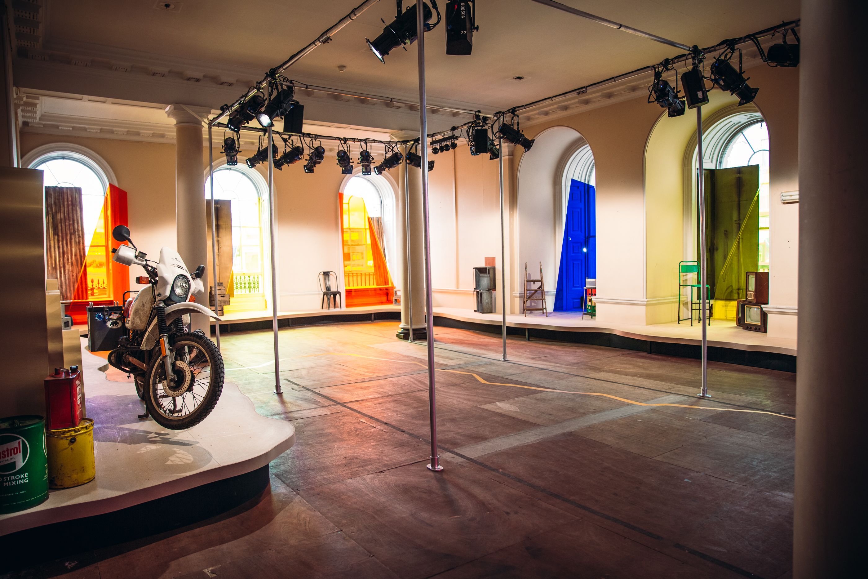 Versatile event space in Somerset House with vibrant panels and motorcycle focal point.