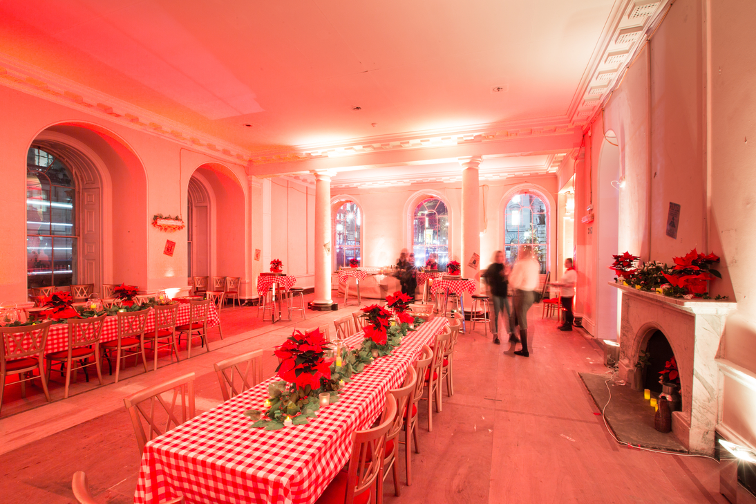 Festive event space at The Lancaster Rooms with red lighting for holiday parties.