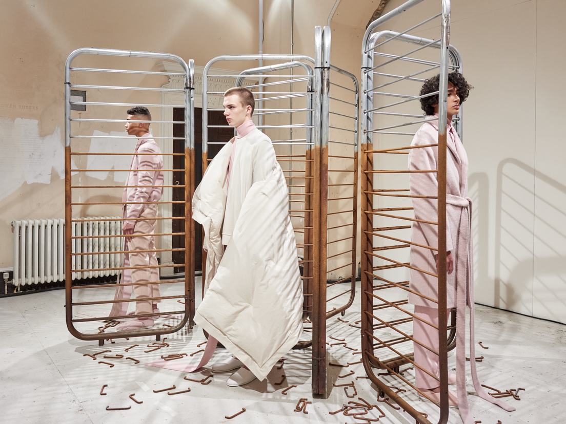 Avant-garde fashion presentation at The River Rooms, Somerset House, minimalist backdrop.