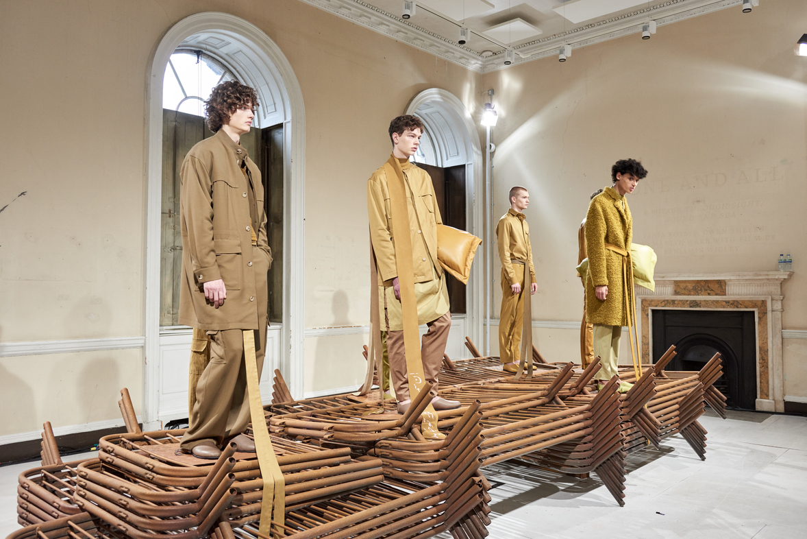 Fashion presentation at The River Rooms, Somerset House with models on a wooden structure.