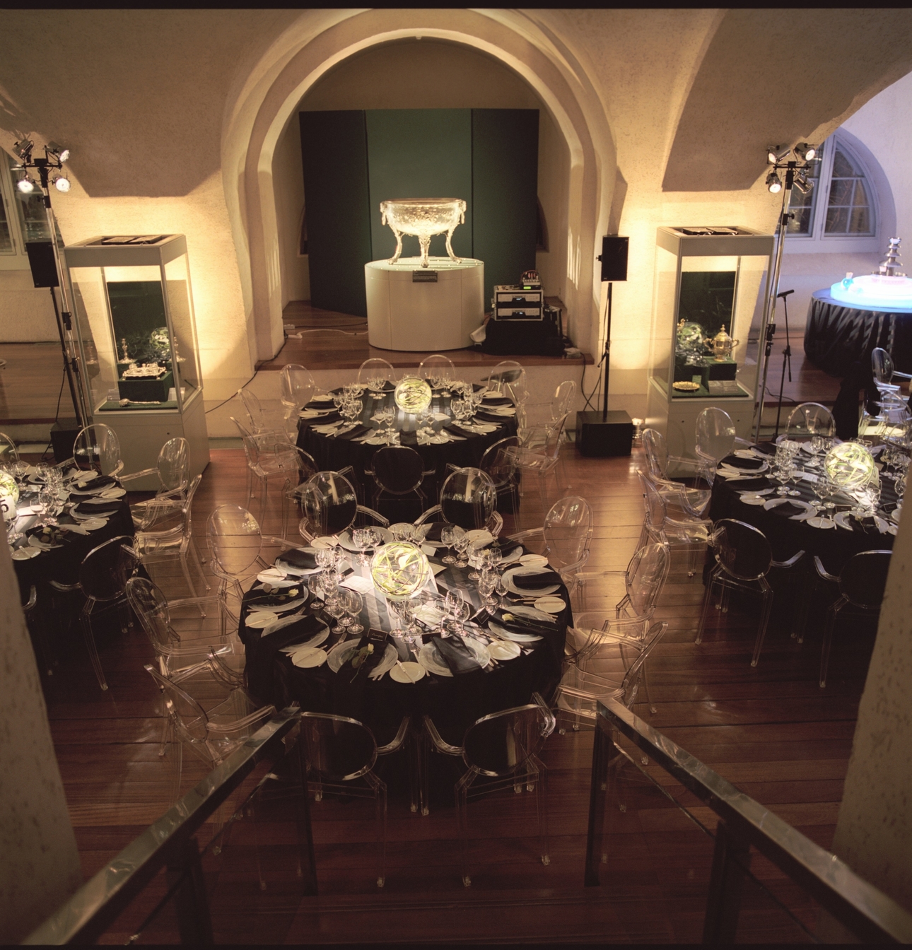 Elegant event setup at Somerset House with black linens and ghost chairs for upscale galas.