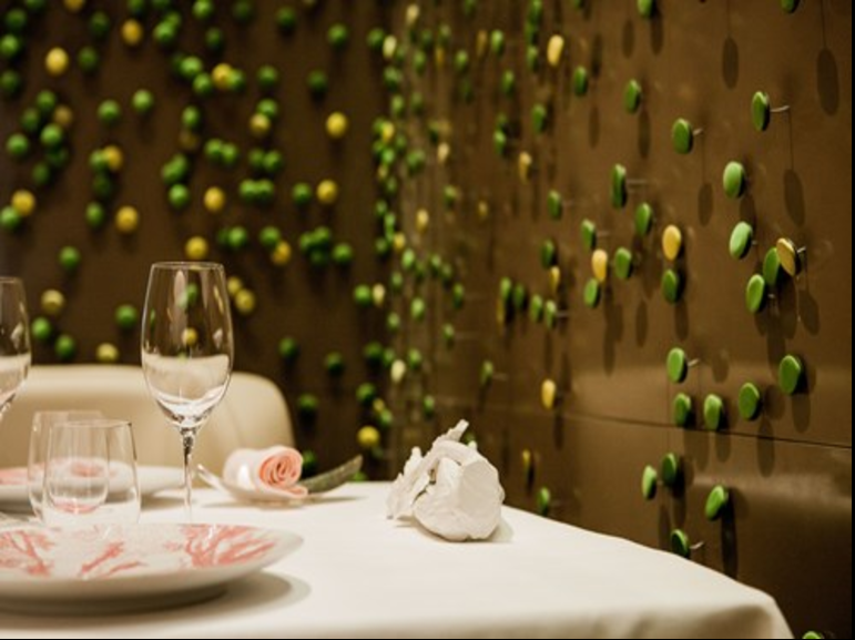 Elegant dining space at Salon Privé, featuring unique wall art for upscale events.