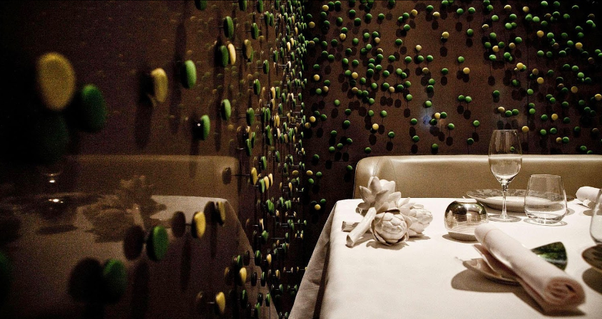 Elegant dining space at Salon Privé, featuring artistic wall design for exclusive events.