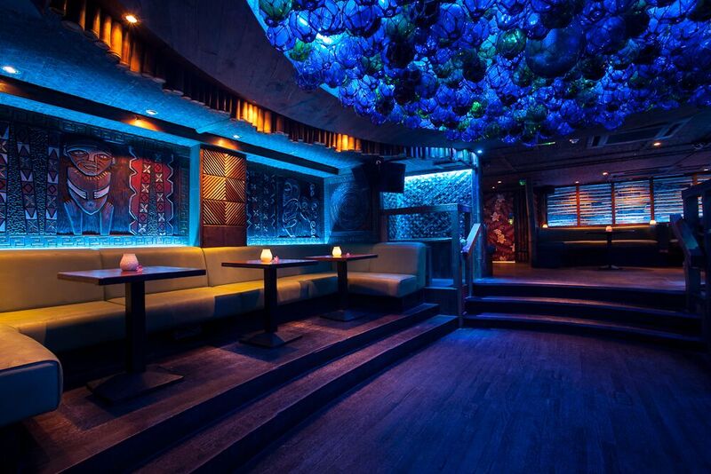 Stylish Mahiki London venue with blue lighting, ideal for cocktail receptions and networking.