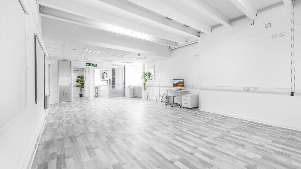 Spacious minimalist meeting room at S3 Royal Arsenal for workshops and events.