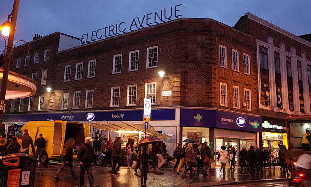 Vibrant event space on Electric Avenue with illuminated signage, perfect for gatherings and shopping.