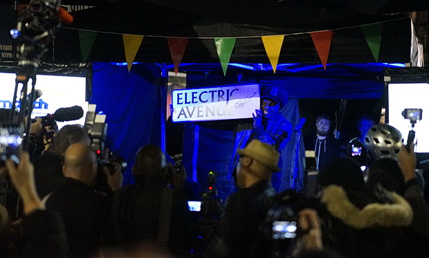 Event Space in Electric Avenue with vibrant stage, engaging crowd at outdoor festival.