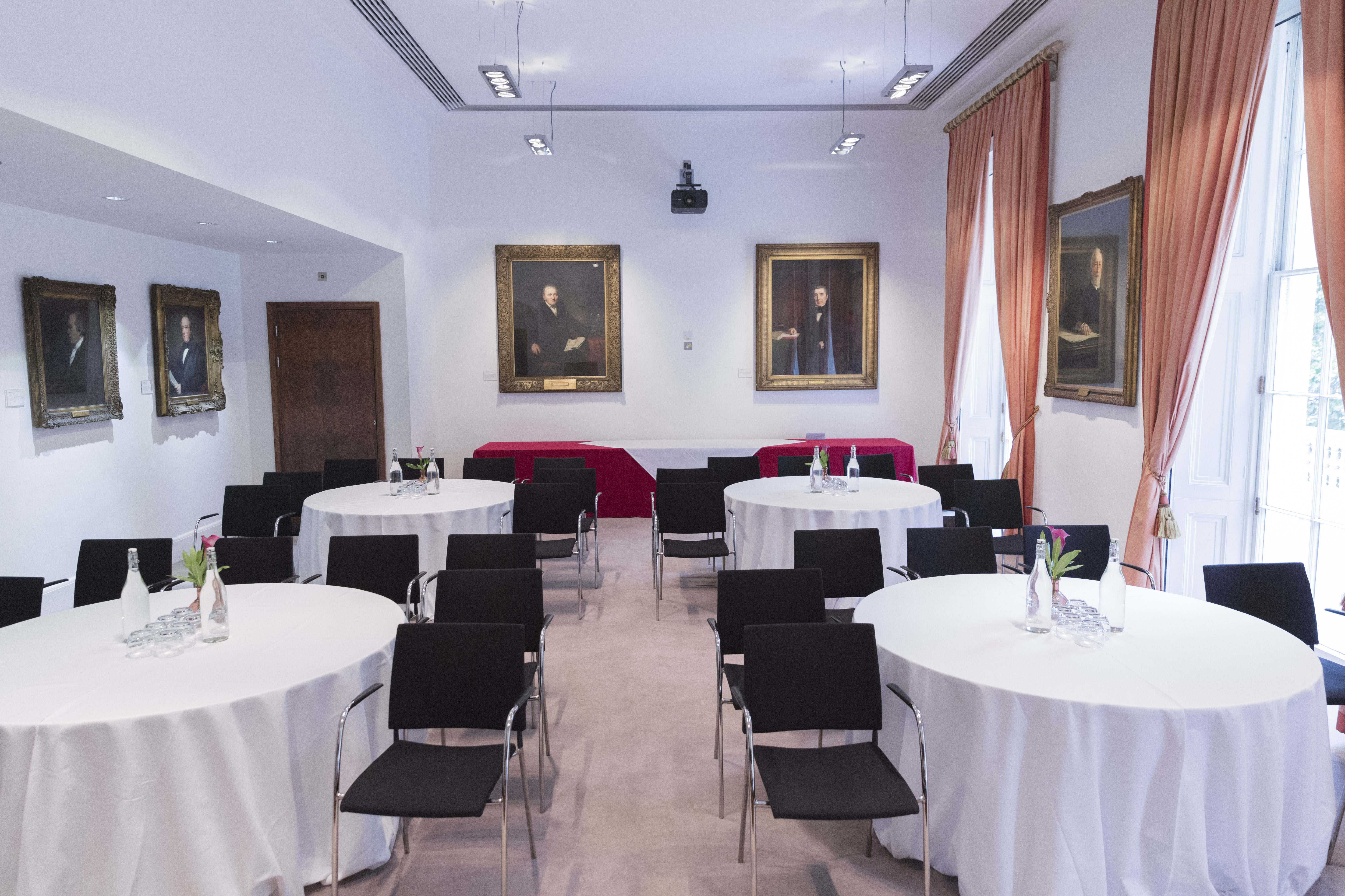 Conference Room at The Royal Society with round tables, ideal for workshops and meetings.