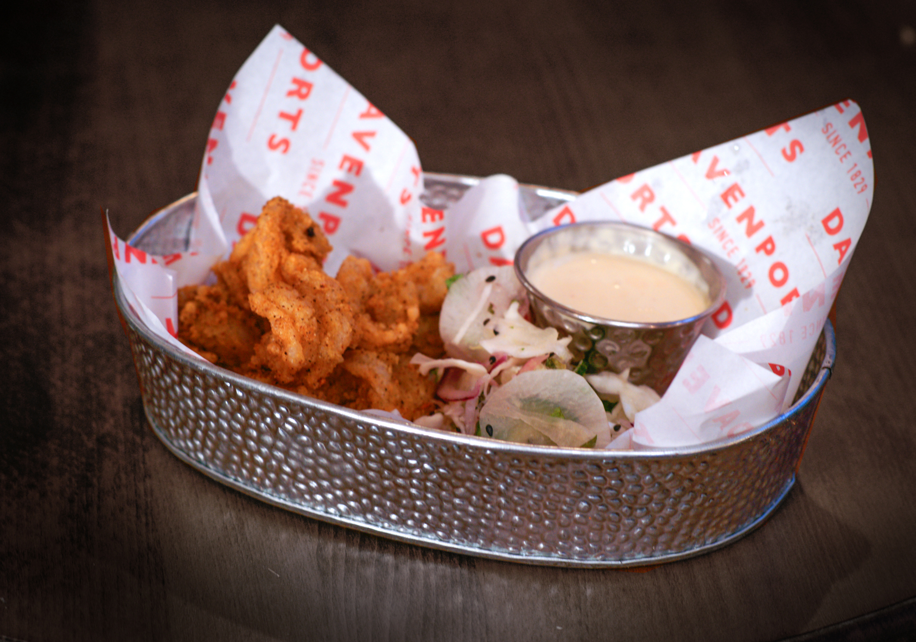 Crispy fried food in a branded basket for networking events at The Bull's Head.