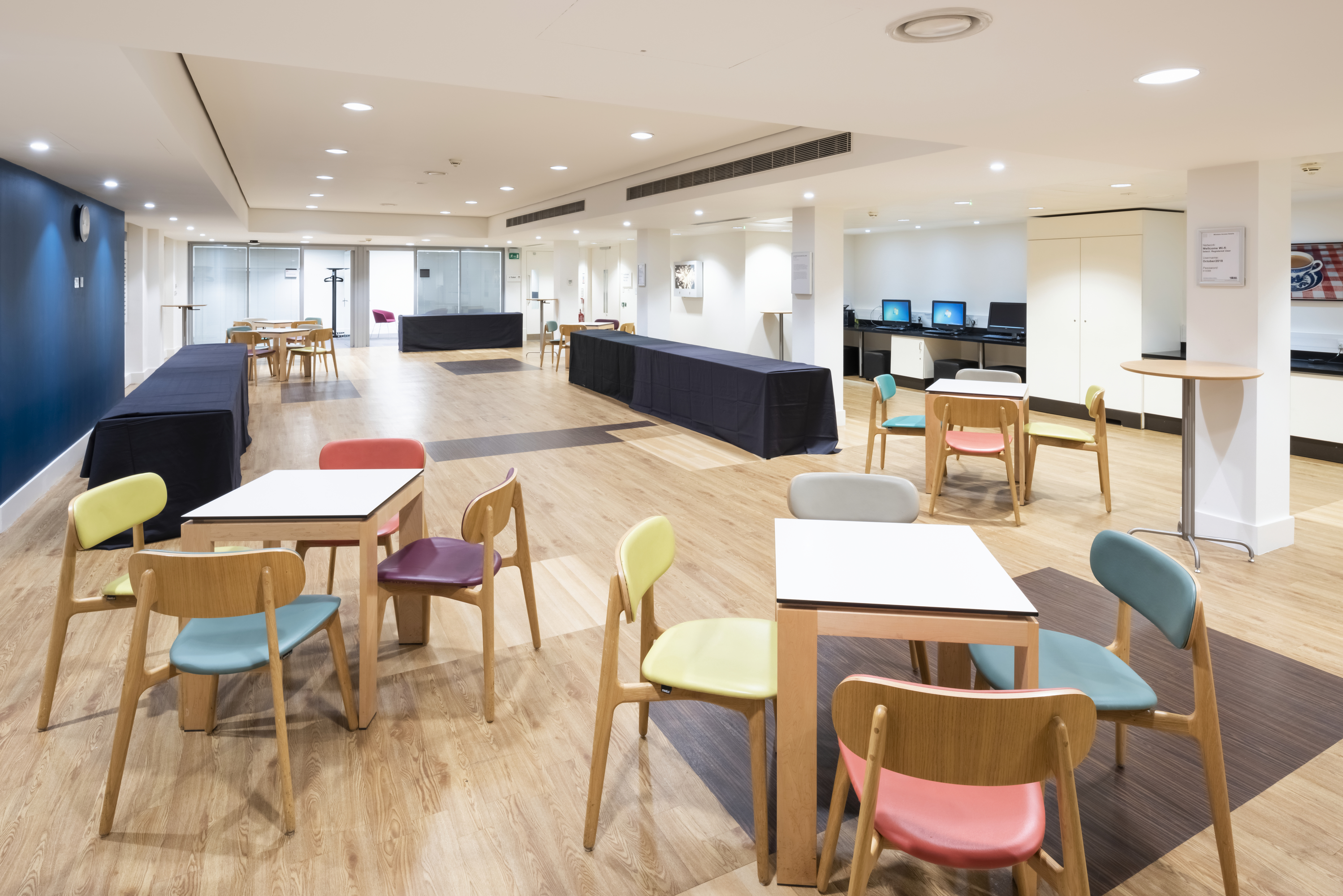 Henry Wellcome Auditorium with modular tables, ideal for workshops and networking events.