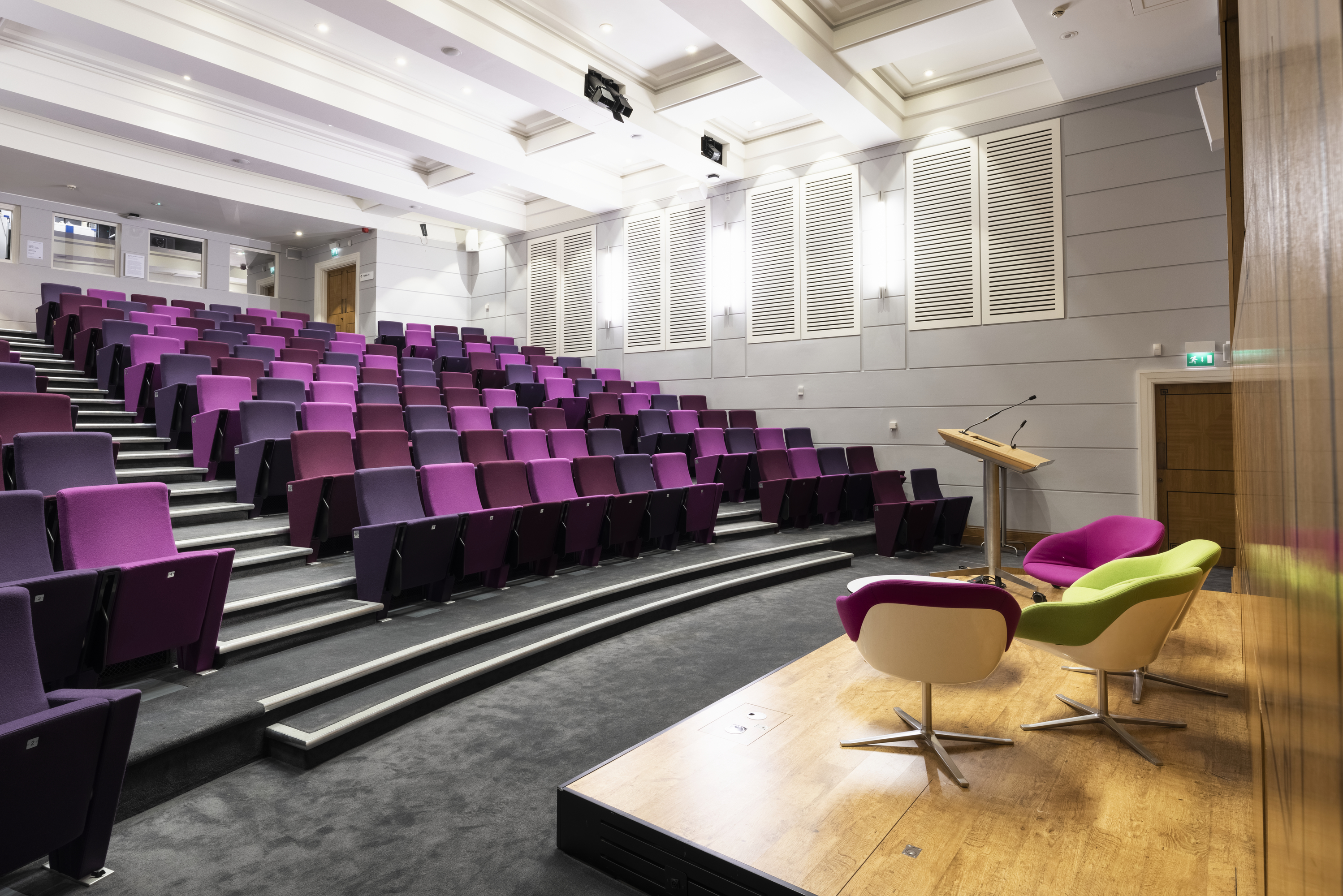 Henry Wellcome Auditorium with tiered purple seating for conferences and workshops.