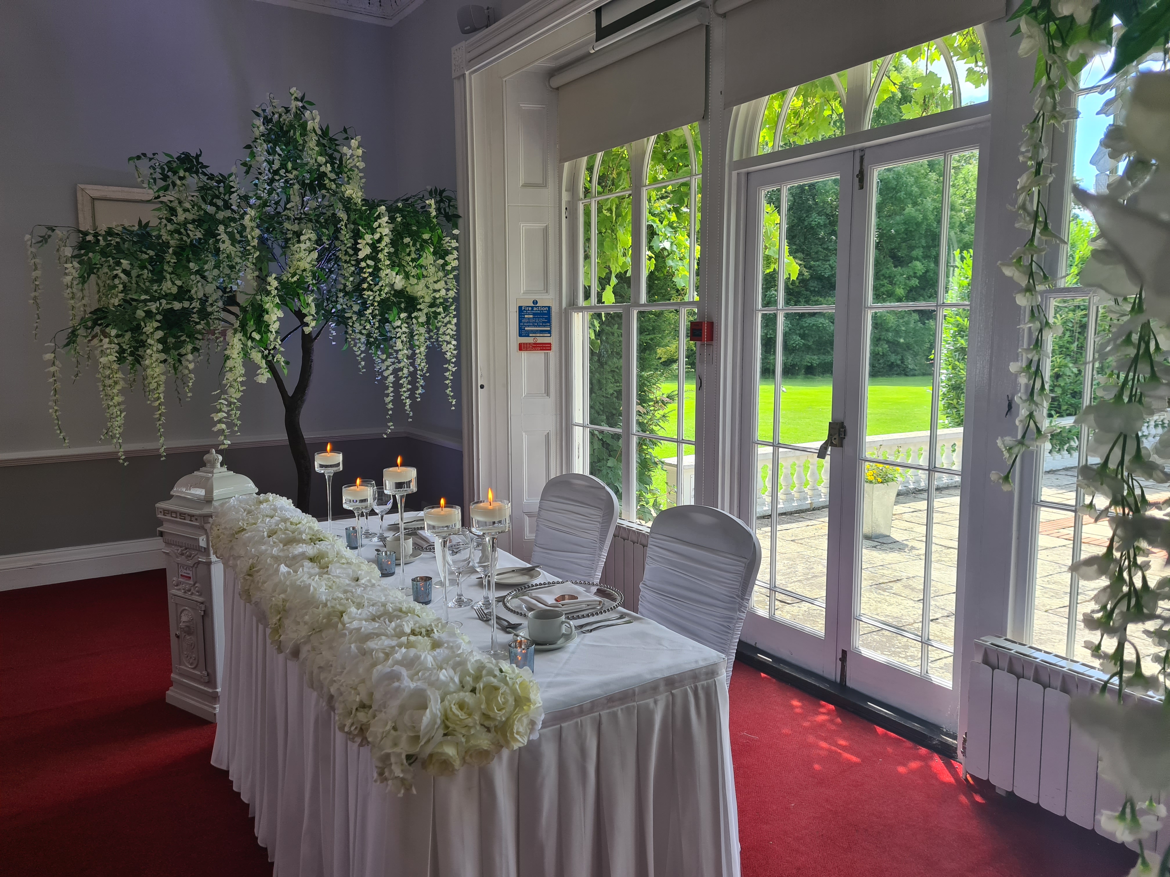 Elegant event space at Manor of Groves with floral decor, perfect for weddings and gatherings.